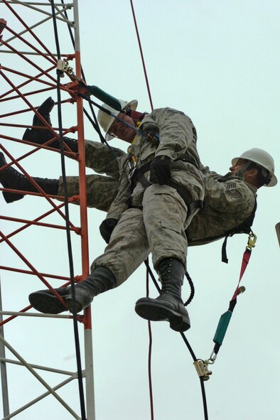 Tech. Sgt. James Lee Norton and Tech. Sgt. Jesus Romeo of the 364th Training Squadron, Sheppard Air Force Base, Texas, practice saving a fellow Airman from a tower in preparation for instructing the Advanced Tower Rescue Course at the Lightning Force Academy at Fort Indiantown Gap, Pa.

