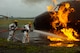 The two man team of a "back-up man" and a "main man" enter the pit and approach the first ground fire at the simulator aircraft. Eleven firefighters from the 193rd Special Operations Wing's Fire Department attended the annual training that lasted four days at Joint Base McGuire-Dix-Lakehurst, N.J.