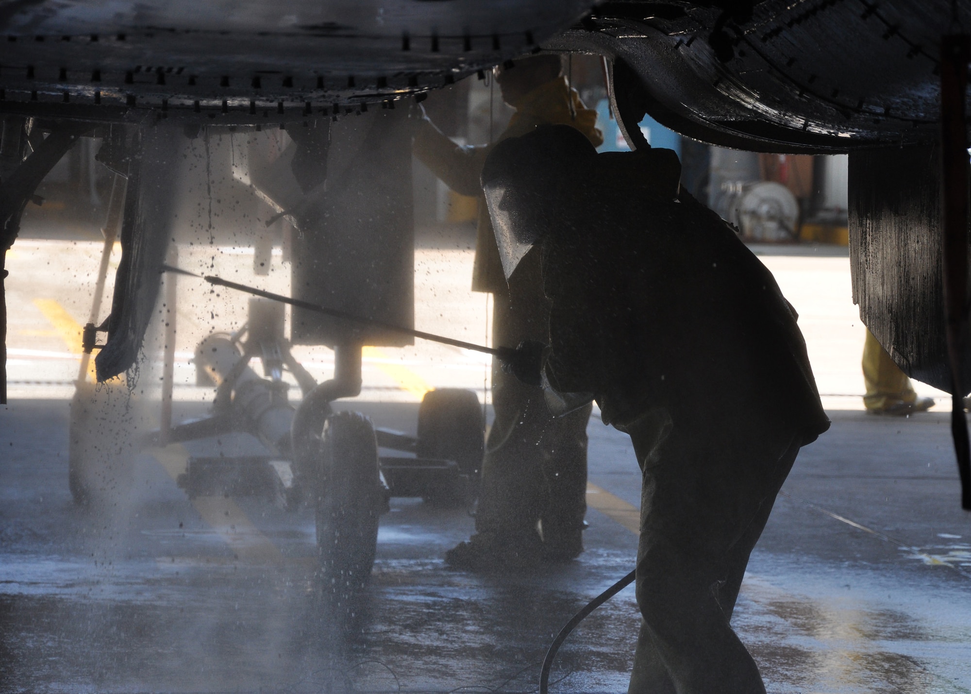 Maintainers thoroughly wash an F-15 free of any residual hydraulic fluid and grime during the process of getting the jet prepared to be a static display for the Northwest Florida regional airport. The aircraft is the second of two 33rd Fighter Wing aircraft to be demilitarized so that it may be put on permanent display. Recently another jet was shipped to the USS Alabama battleship museum.  To make sure it is safe for public use, maintainers gut the aircraft's weapons, explosive devices, ejection seat, engine and anything that holds fluid or is potentially hazardous. After the wash, they will spend one week sealing all openings and another week painting the aircraft.  (U.S. Air Force photo/ Chrissy Cuttita.) 
