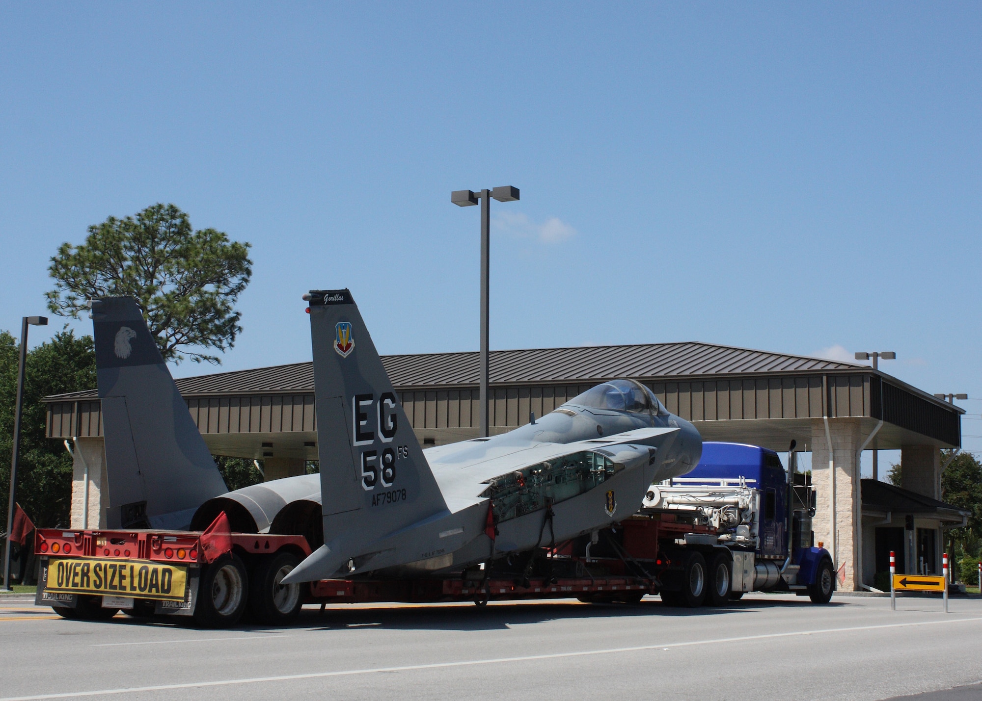 An F-15 from the 33rd Fighter Wing is driven out Eglin's west gate on a transfer truck to be taken to the USS Alabama Battleship Memorial Park, Mobile, Ala. June 6.  The jet was the first of two that was demilitarized by wing maintainers to become permanent display aircraft. (U.S. Air Force photo/ Tech. Sgt. Andrew Gamache.)