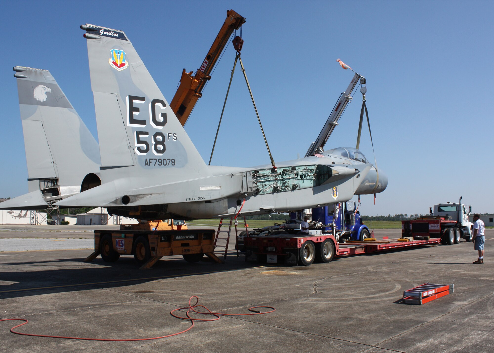 An F-15 from the 33rd Fighter Wing is hoisted onto a transfer truck to be taken to the USS Alabama Battleship Memorial Park, Mobile, Ala., where it will remain on static display.  (U.S. Air Force photo/ Tech. Sgt. Andrew Gamache.)