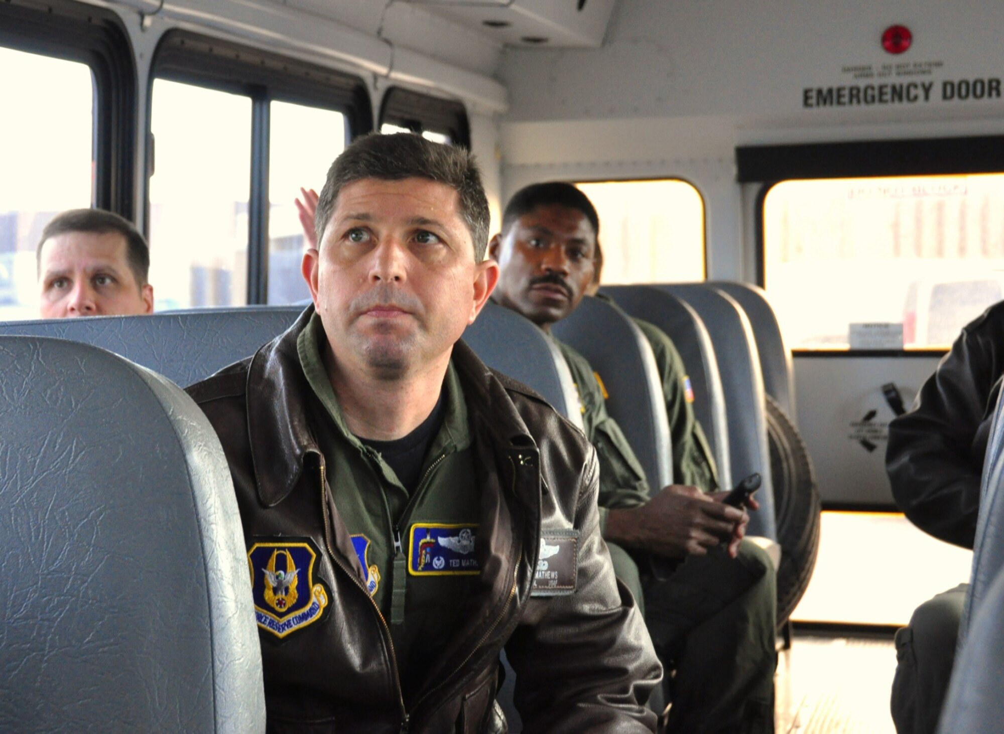 Lt. Col. Ted Mathews, 18th Air Refueling Squadron commander, and other members of his squadron ride on a bus to the flightline at McConnell Air Force Base, Kan. A ceremony to promote Mathews to colonel is scheduled for Saturday, a few hours before he relinquishes command of the 18th ARS to Lt. Col. Tony Brusca during a change of command ceremony. Colonel Mathews has also been named the new vice commander of the 927th Air Refueling Wing at MacDill Air Force Base, Fla. The 18th Air Refueling Squadron is the flying unit of the 931st Air Refueling Group, an Air Force Reserve unit at McConnell Air Force Base, Kan. (Courtesy photo/Lt. Col. Tsuyoshi Tung)