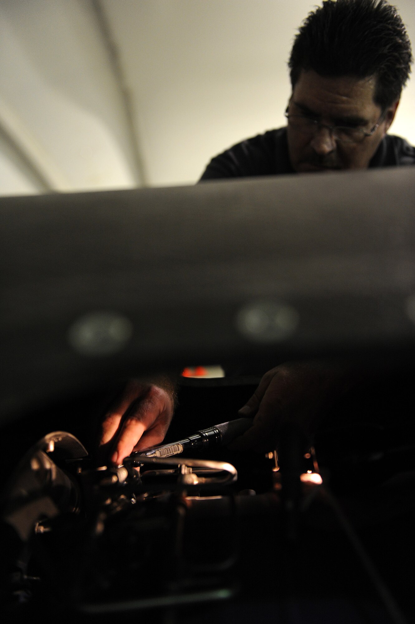 SOUTHWEST ASIA - Mr. Nate Cox, a Northrop Grumman contractor, replaces a fuel nozzle on a Navy RQ-4 Global Hawk, June 10 at an undisclosed location in Southwest Asia. The nozzle is being replaced as part of a 150 flying hour inspection. The Navy Global Hawk is a key factor in maritime surveillance and reconnaissance keeping our Soldiers, Sailors, Marines and Airmen safe. (U.S. Air Force photo by Senior Airman Brian J. Ellis) (Released)