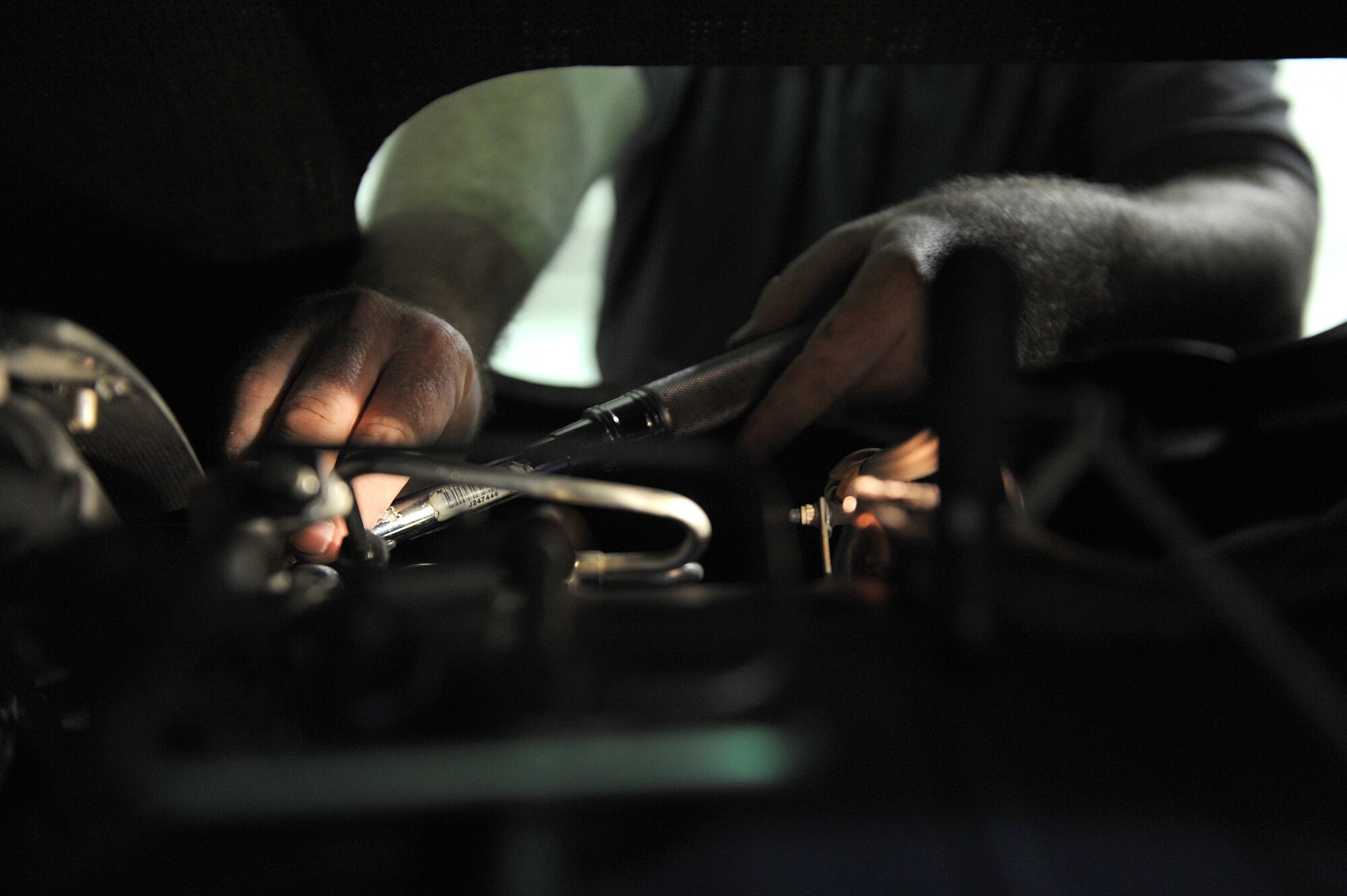 SOUTHWEST ASIA - Mr. Nate Cox, a Northrop Grumman contractor, replaces a fuel nozzle on a Navy RQ-4 Global Hawk, June 10 at an undisclosed location in Southwest Asia. The nozzle is being replaced as part of a 150 flying hour inspection. The Navy Global Hawk is a key factor in maritime surveillance and reconnaissance keeping our Soldiers, Sailors, Marines and Airmen safe. (U.S. Air Force photo by Senior Airman Brian J. Ellis) (Released)