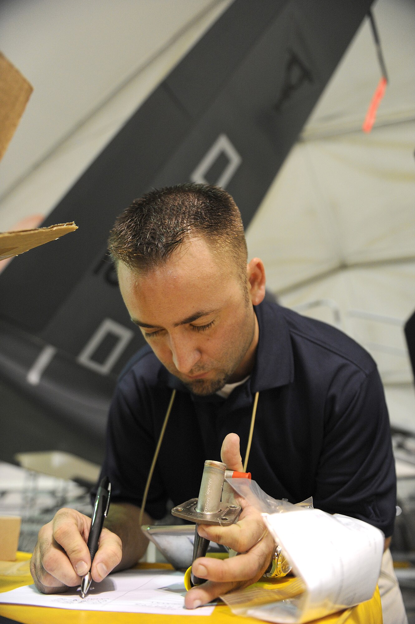 SOUTHWEST ASIA - Mr. Dave Hatch, a Northrop Grumman contractor, verifies the serial number on a fuel nozzle for a Navy RQ-4 Global Hawk, June 10 at an undisclosed location in Southwest Asia. The nozzle is being replaced as part of a 150 flying hour inspection. The Navy Global Hawk is a key factor in maritime surveillance and reconnaissance keeping our Soldiers, Sailors, Marines and Airmen safe. (U.S. Air Force photo by Senior Airman Brian J. Ellis) (Released)