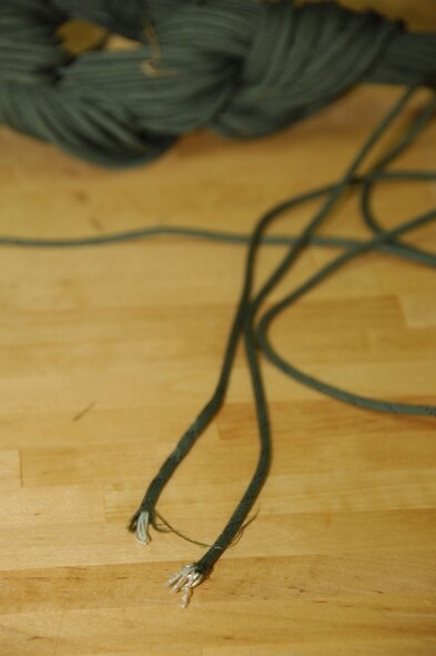 ANDERSEN AIR FORCE BASE, Guam - This frayed suspension line is an example of what aircrew flight equipment technicians look for during an inspection. Finding discrepancies like this ensures the equipment is fully capable of saving the user's life. (U.S. Air Force photo by Senior Airman Shane Dunaway)