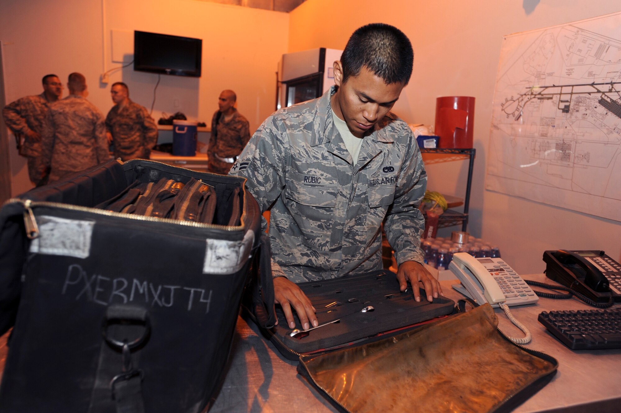Airman 1st Class Phillip Rubic, an airspace propulsion mechanic with the 8th Expeditionary Air Mobility Squadron, ensures all tools are present prior to signing for them during shift change here, June 10, 2009, in an undisclosed location in Southwest Asia.  Prior to going out to the flightline, mechanics must inspect their toolkits to ensure all tools are present and accounted for.  Airman Rubic is native to San Diego Calif. and is deployed from Travis Air Force Base, Calif., in support of Operations Iraqi and Enduring Freedom and Combined Joint Task Force - Horn of Africa.  (U.S. Air Force Photo by Staff Sgt. Joshua Garcia/released)