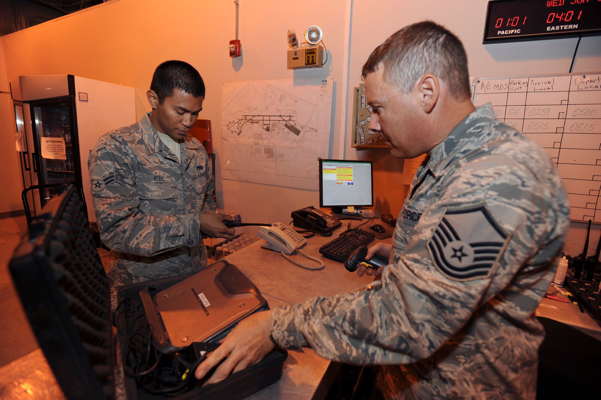 Master Sergeant Bradley Laschanzky(right), a composite toolkit technician with the 8th Expeditionary Air Mobility Squadron, signs out tools to Airman 1st Class Phillip Rubic, an air space propulsion mechanic also with the 379th Expeditionary Air Mobility Squadron, during shift change here, June 10, 2009, in an undisclosed location in Southwest Asia.  At shift change tools that are issued out to the mechanics are scanned into a computer system ensuring their accountability. Sergeant Laschanzky is native to Austin, Texas and is a reservist deployed from Lackland Air Force Base, Texas, while Airman Rubic hails from San Diego, Calif. and is deployed from Travis Air Force Base, Calif. both in support of Operations Iraqi and Enduring Freedom and Combined Joint Task Force - Horn of Africa.  (U.S. Air Force Photo by Staff Sgt. Joshua Garcia/released)