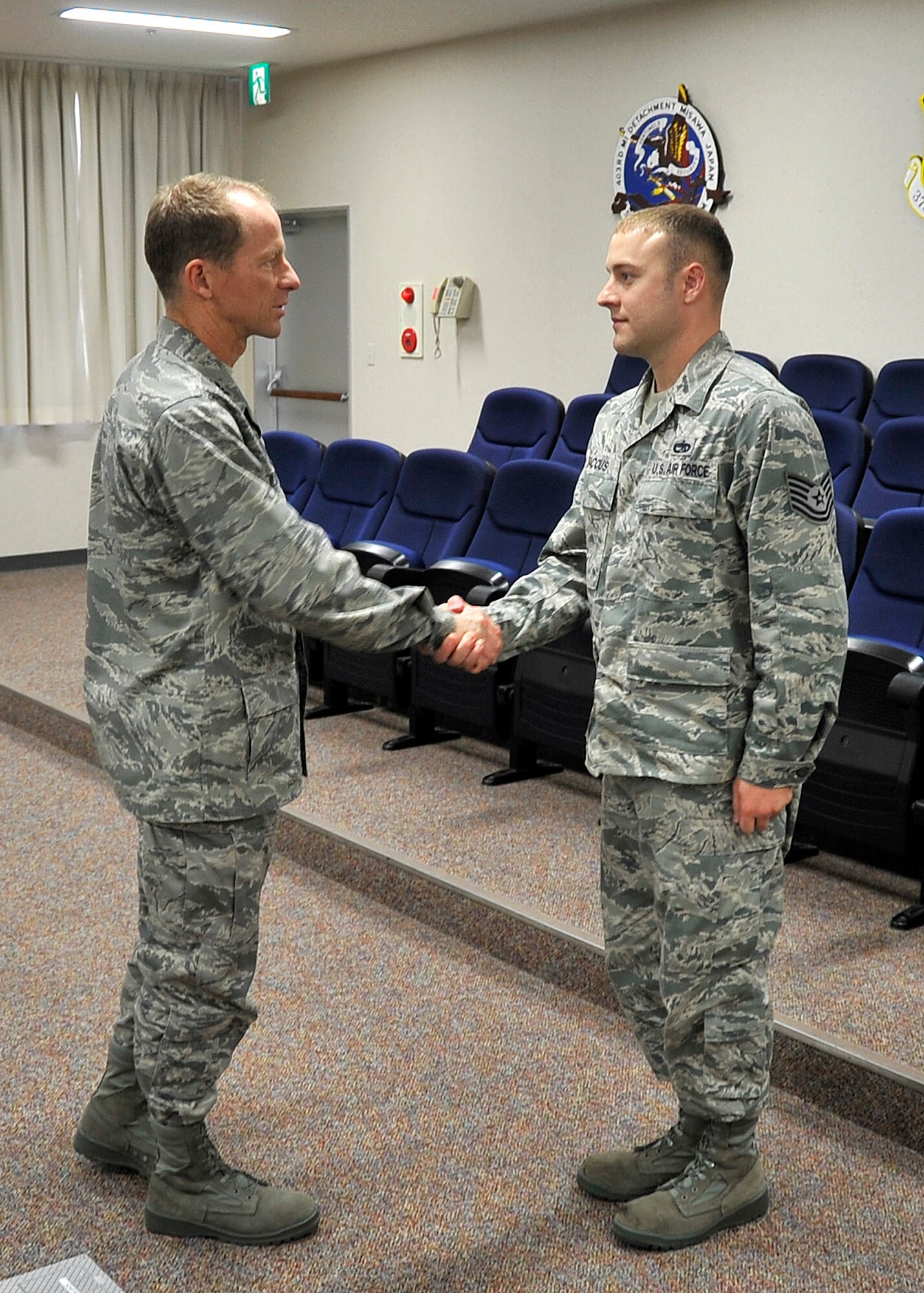 MISAWA AIR BASE, Japan -- Tech Sgt. William Baccus, 35th Maintenance Squadron resource advisor, receives a coin from Col. David Stilwell, 35th Fighter Wing commander, for his achievements in the Noncommissioned Officer Academy at Kadena Air Base June 11, 2009. Sergeant Baccus received the John L. Levitow Award in his class' graduation ceremony. (U.S. Air Force photo by Senior Airman Chad C. Strohmeyer)