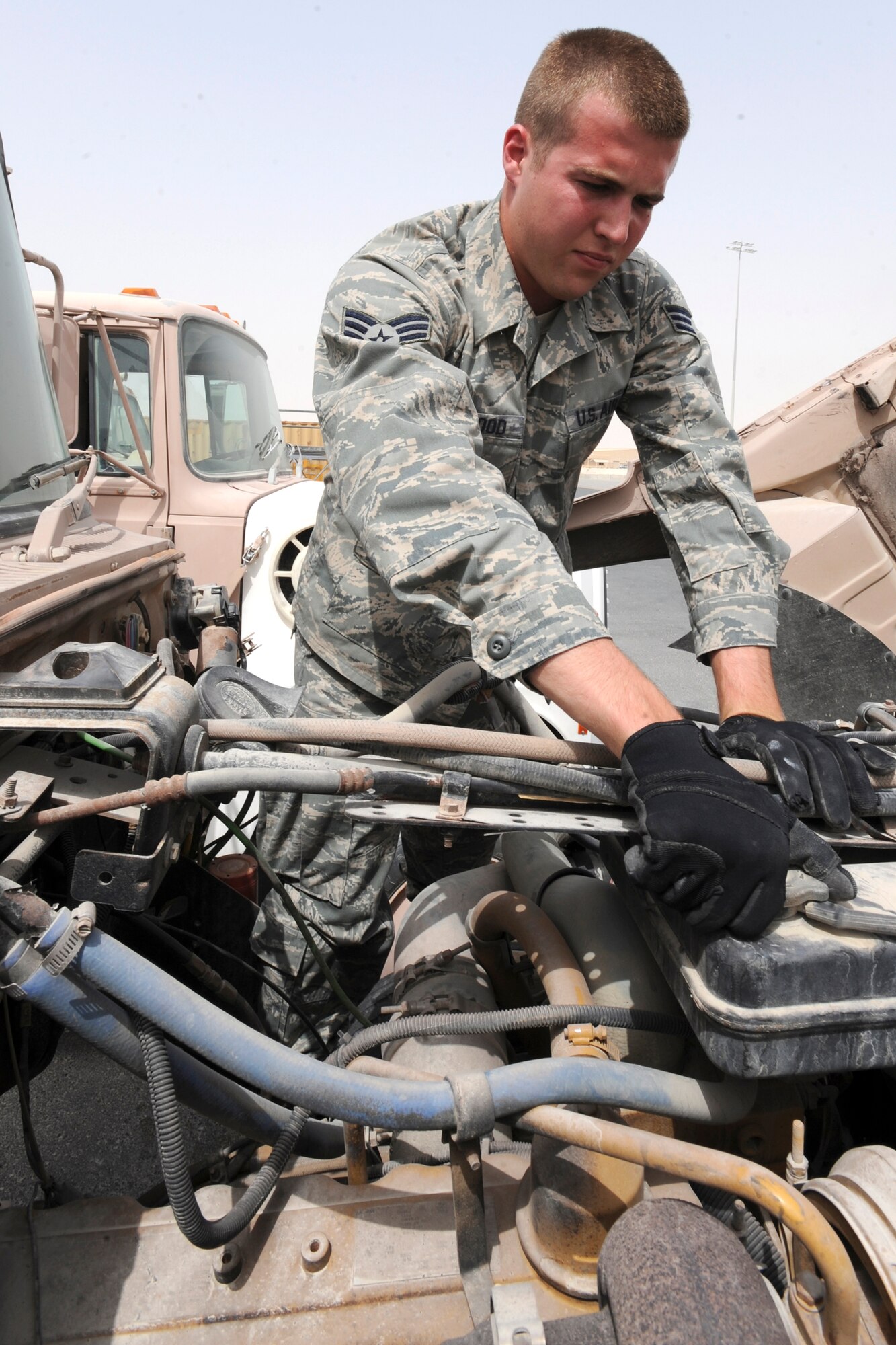 Senior Airman Clinton Portwood, a vehicle control manager for the 8th Expeditionary Air Mobility Squadron, performs a vehicle inspection on a 10 ton tractor here, June 9, 2009, in an undisclosed location in Southwest Asia.  The 10 ton tractor is used to haul baggage trailers to and from aircraft on the flightline.  Airman Portwood is native to Atlanta, Ga. and is deployed from Charleston Air Force Base, S.C., in support of Operations Iraqi and Enduring Freedom and Combined Joint Task Force - Horn of Africa.  (U.S. Air Force Photo by Staff Sgt. Joshua Garcia/released)