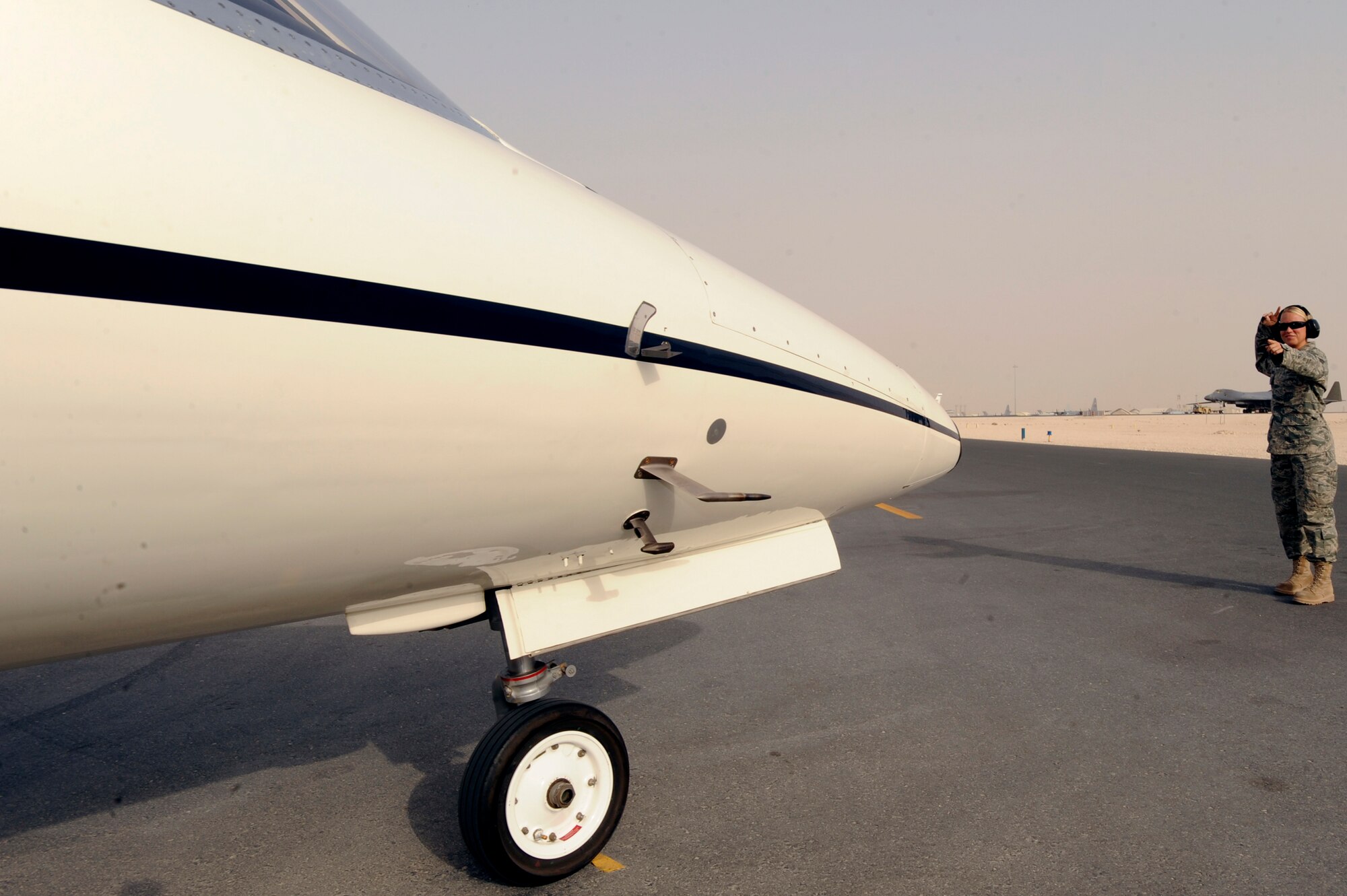 Senior Airman Sarah Rasmussen, an aircraft mechanic with the 119th Aircraft Maintenance Unit, uses hand signals to perform systems checks on a C-21 prior to the start of another mission, June 10, 2009, in an undisclosed location in Southwest Asia.  Airman Rasmussen hails from Moorehead, Minn. and is deployed from the North Dakota Air National Guard in support of Operations Iraqi and Enduring Freedom and Combined Joint Task Force - Horn of Africa.  (U.S. Air Force Photo by Staff Sgt. Joshua Garcia/released)