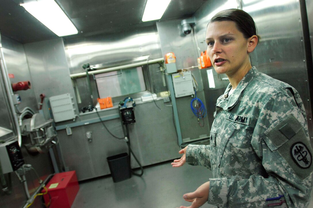 Army Sgt. Sarah Elliott, a biological research assistant at the U.S. Army Research Institute of Environmental Medicine, Natick, Mass., talks about one of the institute’s two altitude chambers. The chambers can simulate altitudes of up to nearly 30,000 feet and temperatures to 25 degrees below zero.