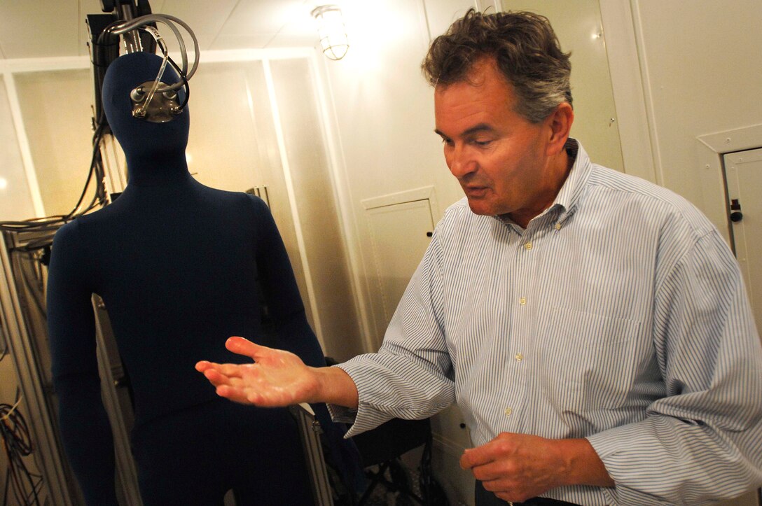 Tom Endrusick, Research Physical Scientist, wipes the sweat from one of two life-sized mannikins, capable of mimicking walking and sweating, at the U.S. Army Research Institute of Environmental Medicine, Natick, Mass. The mannikins are used to test the thermal and vapor-resistance values of uniforms. 