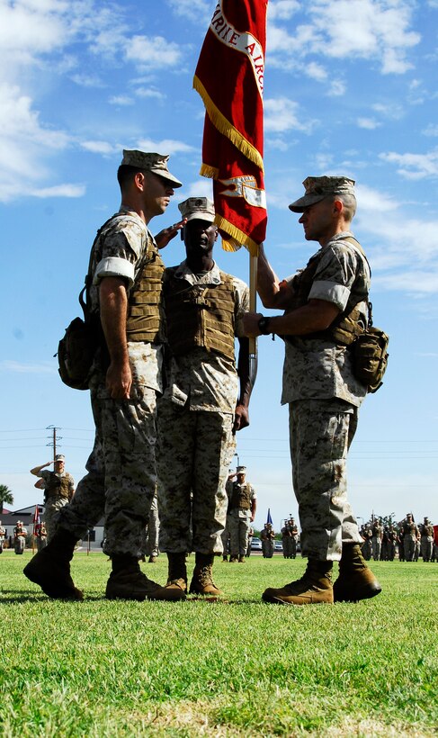 Col. Clyde M. Woltman, former Marine Aircraft Group 13 commanding officer, right, passes the unit’s colors to the new commanding officer, Col. Anton H. Nerad, during their change of command ceremony at the Marine Corps Air Station in Yuma, Ariz., June 12, 2009. Woltman will continue on to Headquarters Marine Corps in Washington, D.C., to work in the plans, policies and operations department. Nerad is taking command of the unit after serving in various billets with the 1st Marine Aircraft Wing in Okinawa, Japan.