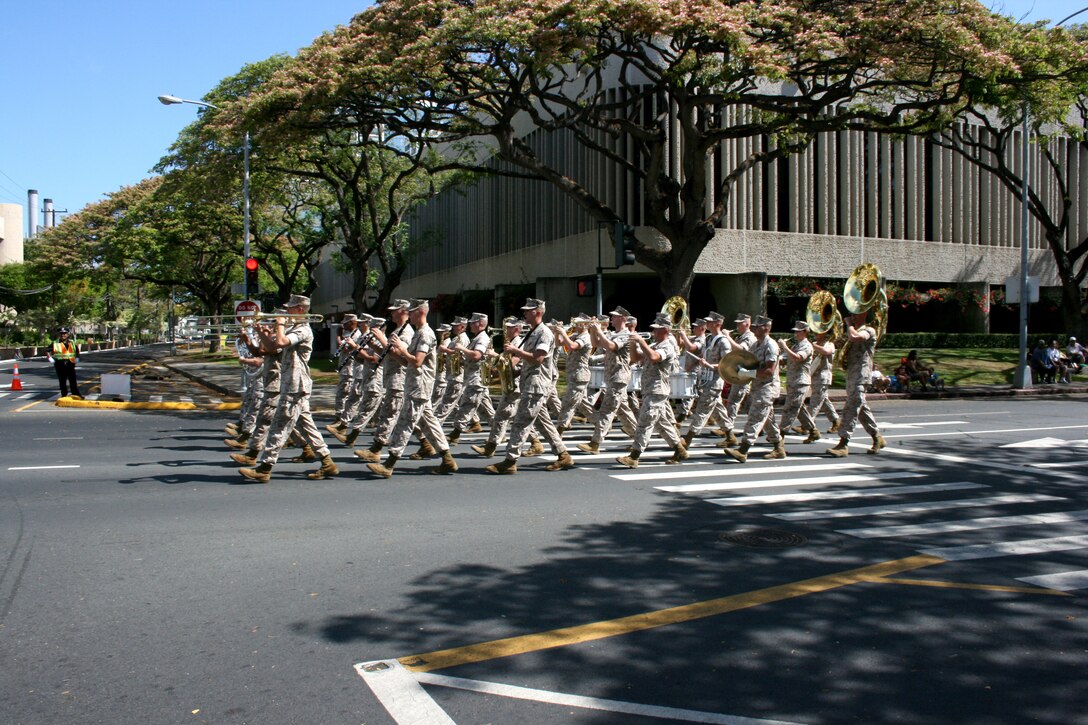 The U.S. Marine Corps Forces Pacific Band serenades onlookers with 'Waltzing Matilda' during the 93rd King Kamehameha Day Floral Parade in Honolulu, Hawaii, on Saturday, June 13, 2009.  The annual parade features floats, mounted units, and military and high school bands and marching units.  The 4.3-mile parade route starts at Iolani Palace in downtown Honolulu and makes its way through Waikiki to Kapiolani Park.