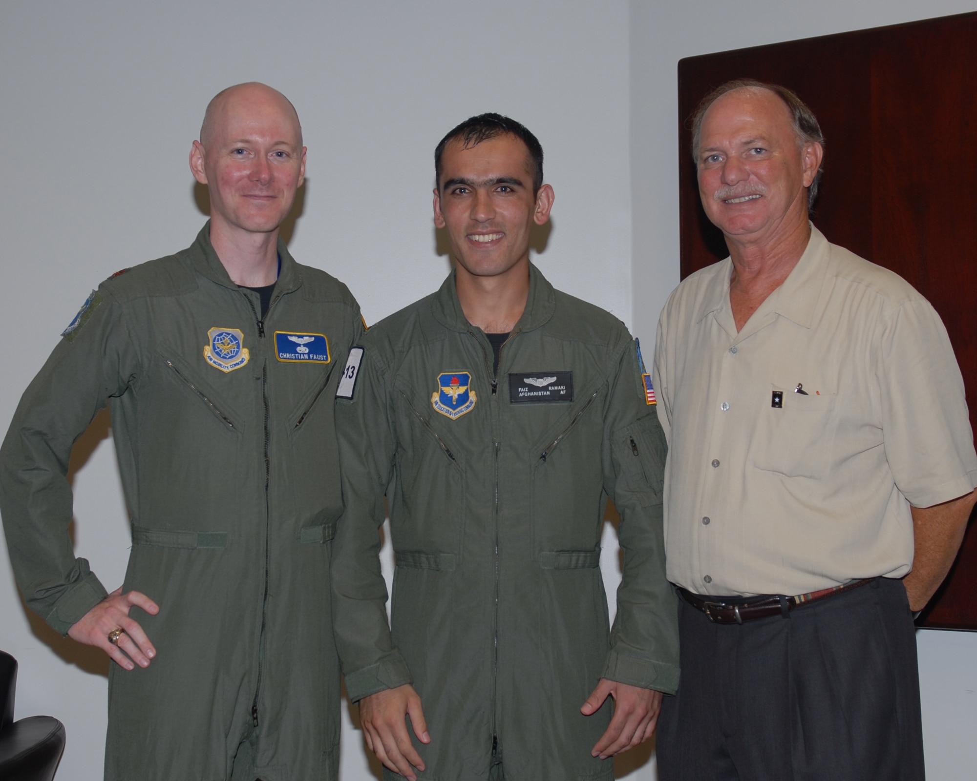 Afghan National Army Air Corps Lieutenant Faiz Ramaki poses with two of his American mentors after receiving his Air Force wings at special graduation ceremony June 12. Lt. Ramaki is the first Afghan student to graduate from U.S. pilot training in almost 50 years. Major Christian Faust and CW4 (ret) Ronald Warner where stationed in Afghanistan when Lt. Ramaki was selected for the Aviation Leadership Program. (US Air Force Photo/Melissa Duncan)