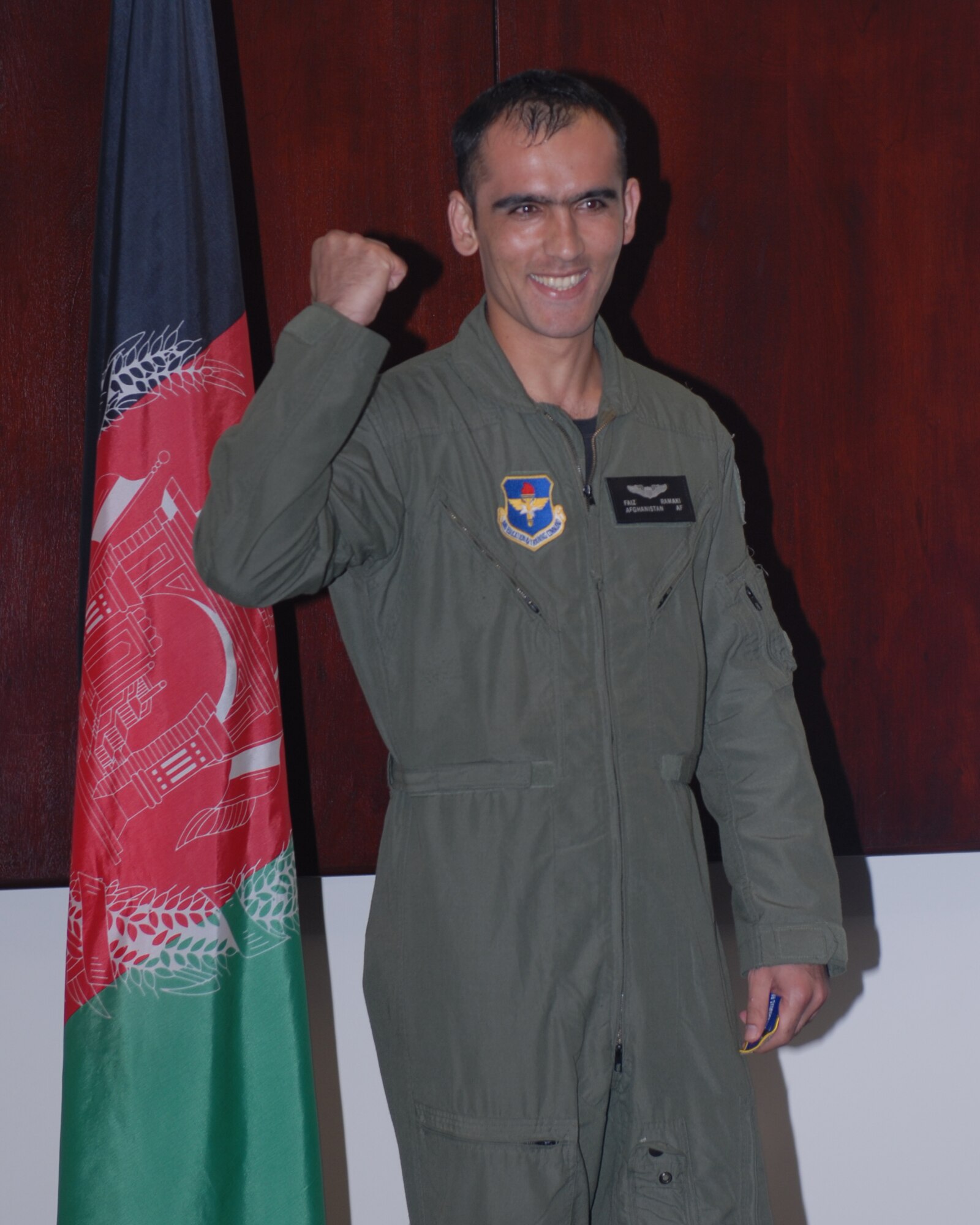 Afghan National Army Air Corps Second Lieutenant Faiz Ramaki shows his joy following his Aviation Leadership Program graduation ceremony Jun 12.  Lt. Ramaki will go to fly the C-27A Spartan in the Afghan Air Corps. (US Air Force Photo/Melissa Duncan)