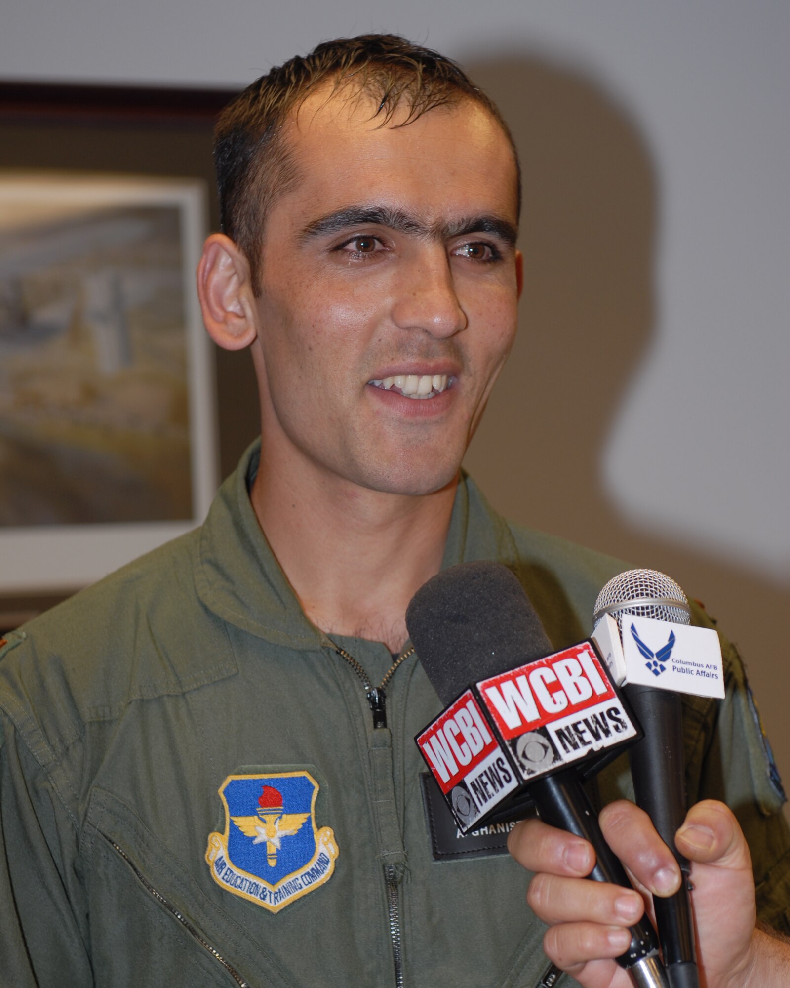 Afghan National Army Air Corps Lt. Faiz Ramaki speaks to press following his Aviation Leadership Program graduation ceremony Jun 12. Lt. Ramaki is the first Afghan student to graduate from U.S. pilot training in almost 50 years.  Lt. Ramaki will go to fly the C-27A Spartan in the Afghan Air Corps. (US Air Force Photo/Melissa Duncan)
