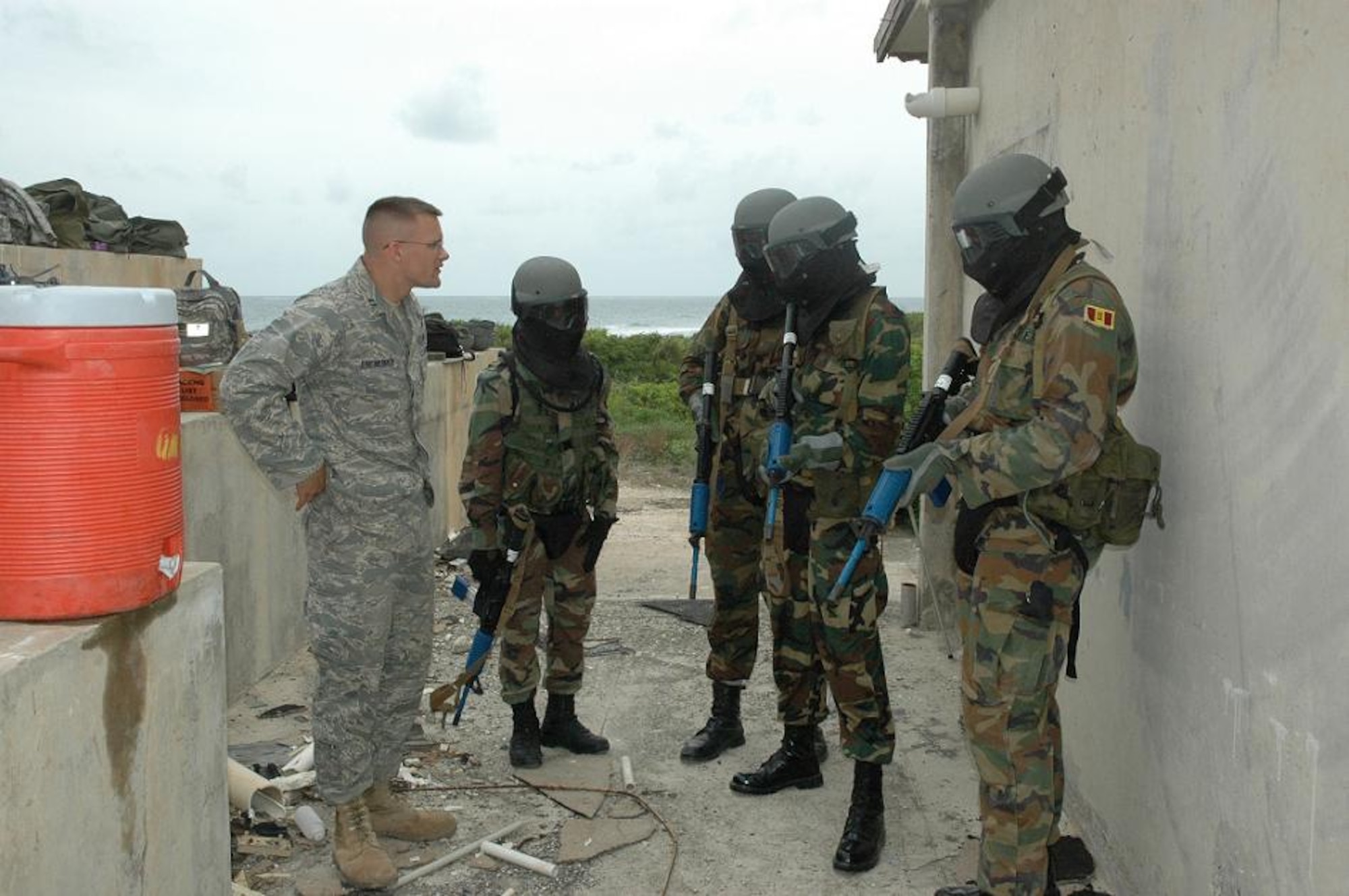 Capt. Donald Bartholomew (left), 820th Security Forces Group operations officer, discusses building entry procedures with Jamaican Defence Force personnel during training session held Monday. The cooperative exchange between Air Force security force personnel and Jamaican Defence Forces was part of Operation Southern Partner. (U.S. Air Force photo by Kevin Walston)