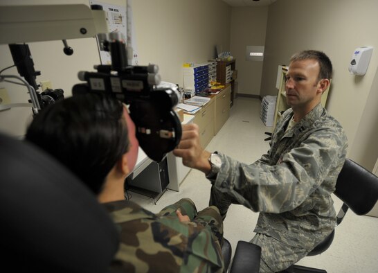 Capt. (Dr.) Chad Thompson examines the eyes of a Reservist during the 931st Air Refueling Group's drill weekend in June. Captain Thompson, a Reserve optometrist assigned to the 931st Aerospace Medicine Squadron, was named the 2009 Young Optometrist of the Year by the Kansas Optometric Asscociation. (U.S. Air Force photo/Tech. Sgt. Jason Schaap)