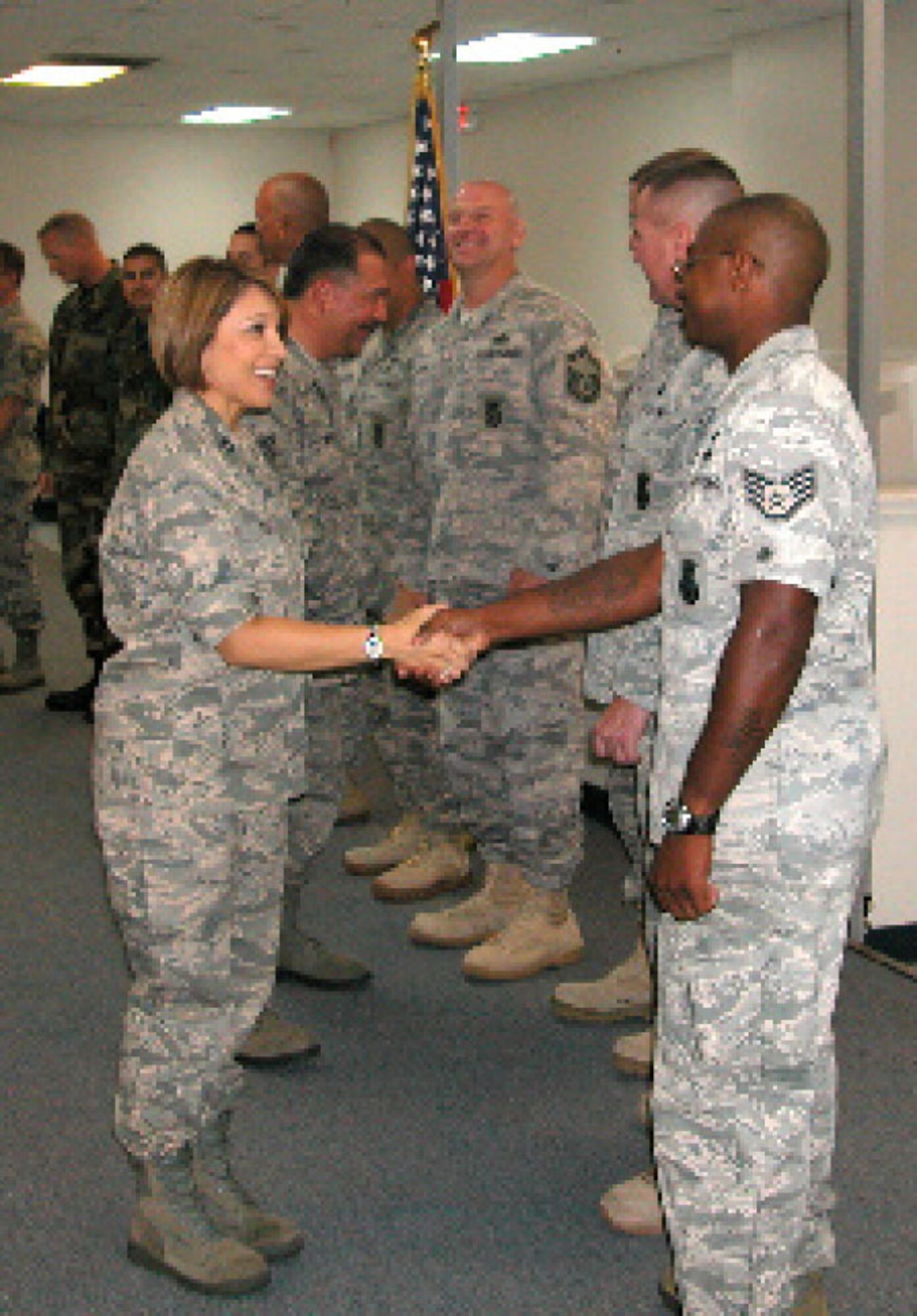 Capt. Anna Ruiz, Executive Officer of Mission Support Group, congratulates Staff Sgt. Paul E. Hardy on his re-enlistment. (U.S. Air Force photo by Megan Just)