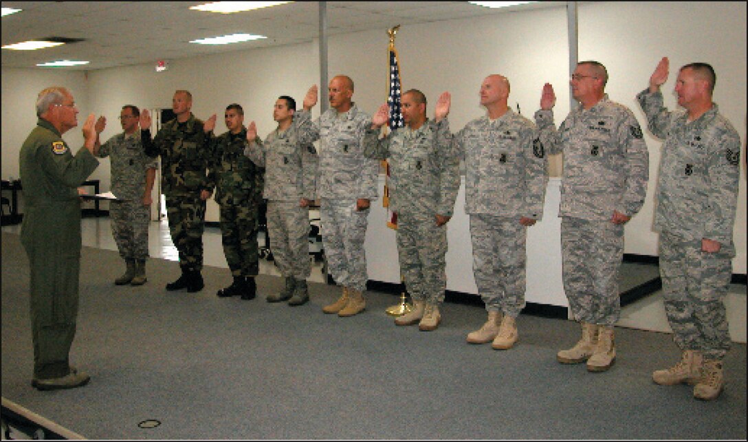 Brig. Gen. James L. Melin administers the re-enlistment oath to 10 Airmen from the 452nd Security Forces Squadron. (From left) Master Sgt. Thomas P. Moffit, Tech. Sgt. Anthony R. Villarreal, Tech. Sgt. Enrique Pizano, Staff Sgt. Giovani L. Moscoso, Master Sgt. Ralph L. Elderbaum, Master Sgt. Christopher P. Jugas, Senior Master Sgt. Donald R. Houfek, Tech. Sgt. Bryan D. Edwards, Tech. Sgt. Joseph A. Legrone, and Staff Sgt. Paul E. Hardy. (U.S. Air Force photo by Megan Just)