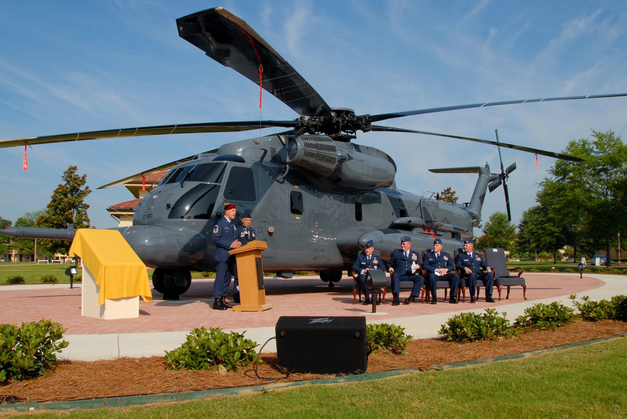 An “old war bird” was dedicated Monday when a ceremony for Air Force Pave Low #69-5785, or 785, was held at Maxwell’s Air Park. The static display at the corner of Ash and Twining Streets commemorates the Airmen who flew the helicopters first assigned to the Air Force in 1970. Retired Chief Master Sgt. Wayne Fisk, a pararescue jumper who flew on 785 many times, told the audience about the aircraft and his association with it. On the right, Lt. Gen. Allen Peck, Air University commander, Brig. Gen. Tom Trask of Air Force Special Operations Command, Col. Kris Beasley, 42nd Air Base Wing commander, and Maj. Brian Roberts, who flew 785 on her last flight, listened to Chief Fisk’s speech. (U.S. Air Force photo/Jamie Pitcher)