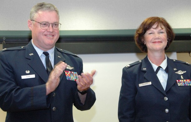 JOINT BASE MCGUIRE-DIX-LAKEHURST -- Col. Paulette R. Schank, right, receives applause after assuming command of the 514th Aerospace Medicine Squadron during a recent Assumption of Command Ceremony officiated by Col. James L. Kerr, commander, 514th Air Mobility Wing. (U.S. Air Force photo/Master Sgt. Donna T.  Jeffries)