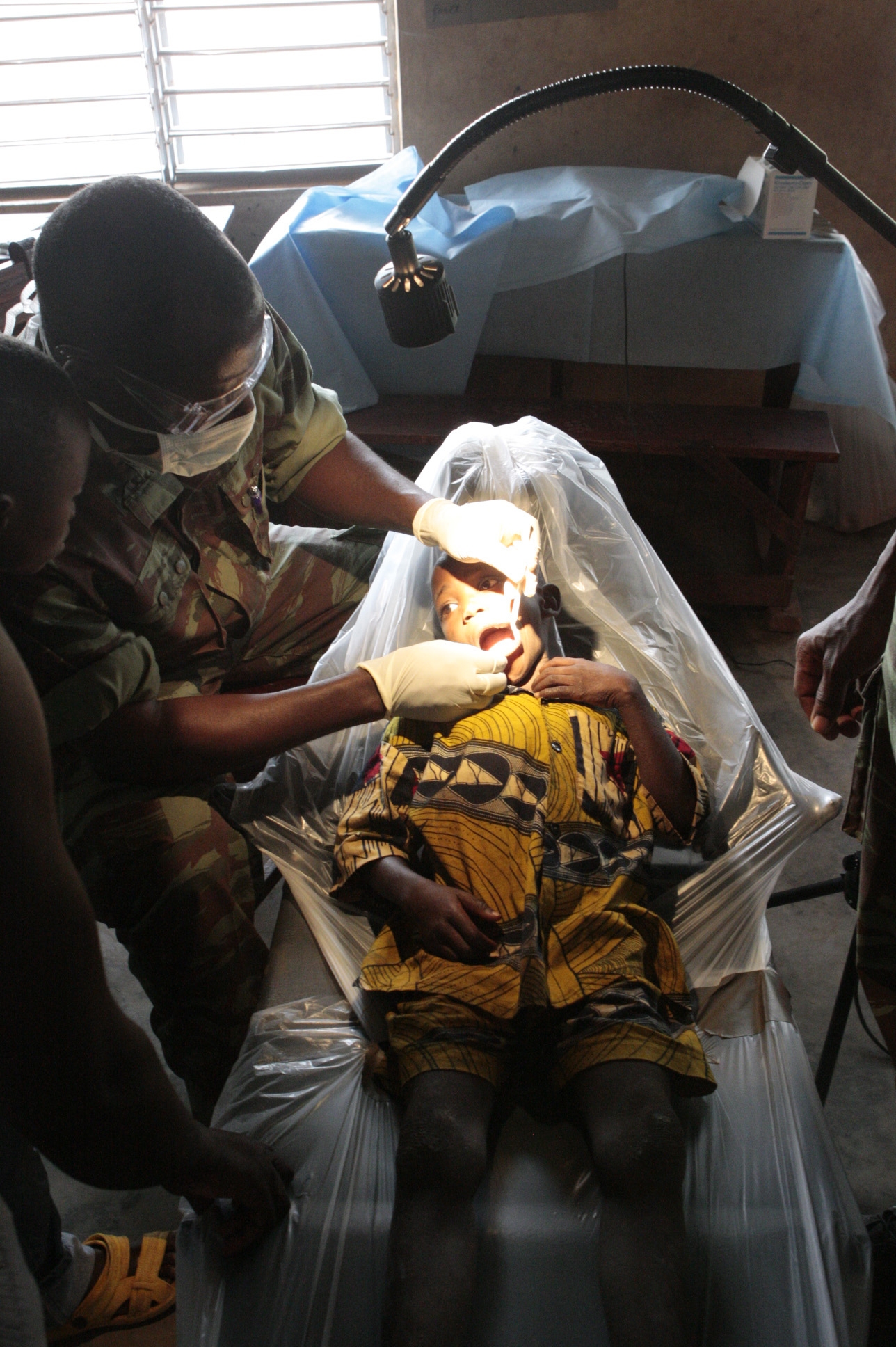 BEMBEREKE, Benin (June 13, 2009)- A Beninese dental technicians treats a patient at a free dental clinic in the village of Sinende as part of Exercise SHARED ACCORD 2009.::r::::n::SHARED ACCORD is a scheduled, combined U.S.-Benin exercise designed to improve interoperability and mutual understanding of each nation’s military tactics, techniques and procedures. Humanitarian and civil affairs events run concurrent with the military training. The exercise is scheduled to conclude June 25.