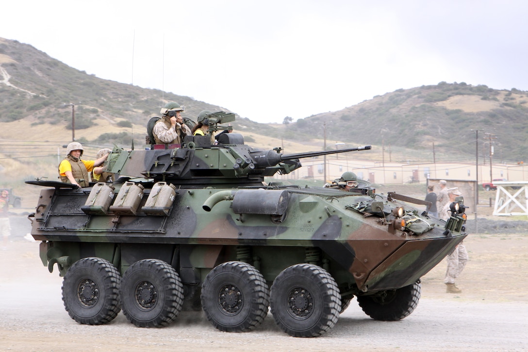 Family members ride inside a Light Armored Vehicle during the School of Infantry West Jane Wayne Day, June 13. Light Armored Vehicles were used at the event to transport family members throughout the stations.