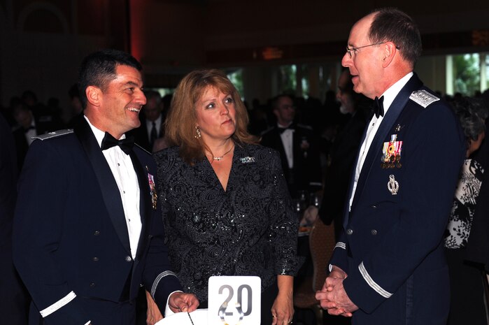 Brig. Gen. Russell Handy, 57th Wing Commander, and JoAnn Handy, Spouse of Brig. Gen. Handy, speak to Gen. Robert Kehler, Commander of Air Force Space Command, at the U.S. Air Force Weapons School graduation; Jun. 13. Since Sept. 11, 2001 Airmen have amassed more than 440,000 combat flying hours operating 24 hours a day, 365 days a year, providing joint force commanders critical intelligence, surveillance, reconnaissance and strike capabilities. (U.S. Air Force photo by Airman 1st Class Brett Clashman)