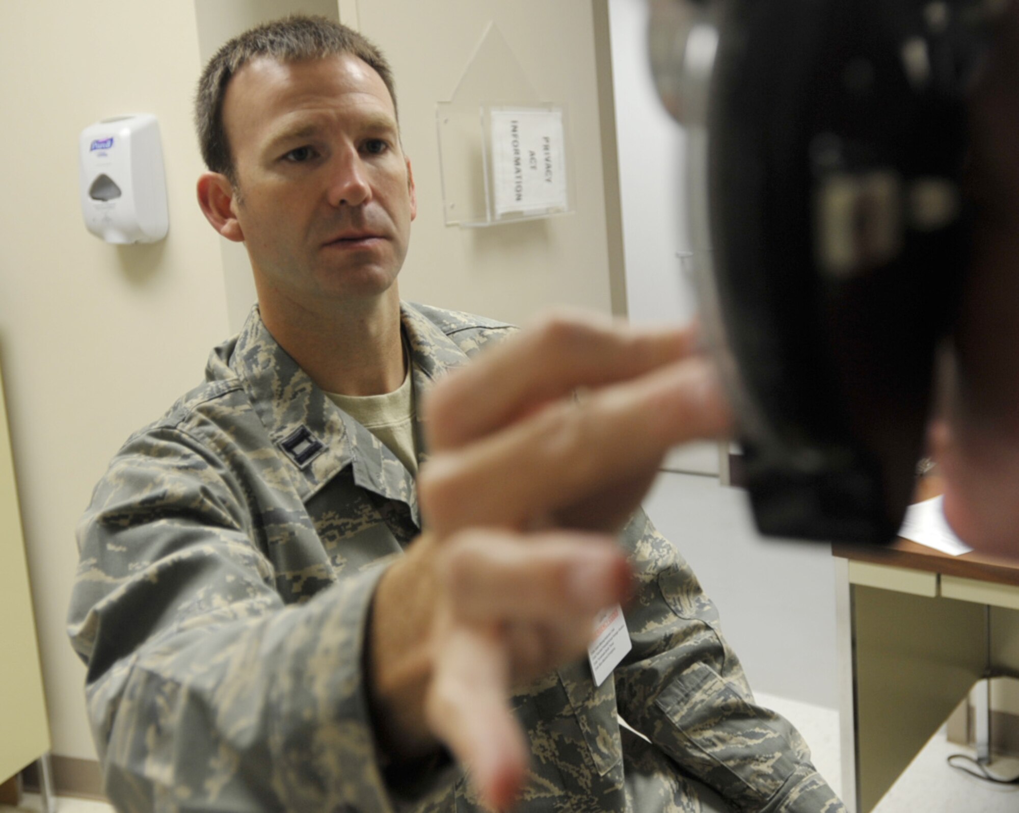Capt. (Dr.) Chad Thompson examines the eyes of a Reservist during the 931st Air Refueling Group's drill weekend in June. Captain Thompson, a Reserve optometrist assigned to the 931st Aerospace Medicine Squadron, was named the 2009 Young Optometrist of the Year by the Kansas Optometric Asscociation. (U.S. Air Force photo/Tech. Sgt. Jason Schaap)

