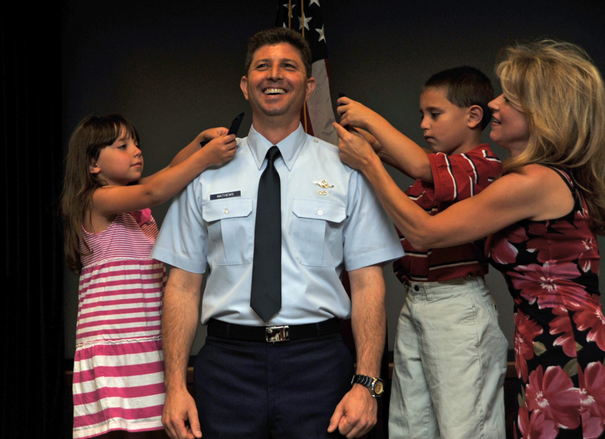 Col. Ted Mathews enjoys the moment during his promotion ceremony Saturday. Helping pin on the eagles that represent his new colonel rank are his sister, Catherine Mathews, his nephew, Joseph, and his niece, Gabrielle. Colonel Mathews relinquished command of the 18th Air Refueling Squadron to Lt. Col. Tony Brusca during a ceremony a few hours later. The 18th ARS is the flying squadron of the 931st Air Refueling Squadron. Colonel Mathews, a KC-135 Stratotanker pilot, has been named as the next vice commander of the 927th Air Refueling Wing at MacDill Air Force Base, Fla. (U.S. Air Force photo/Tech. Sgt. Jason Schaap) 