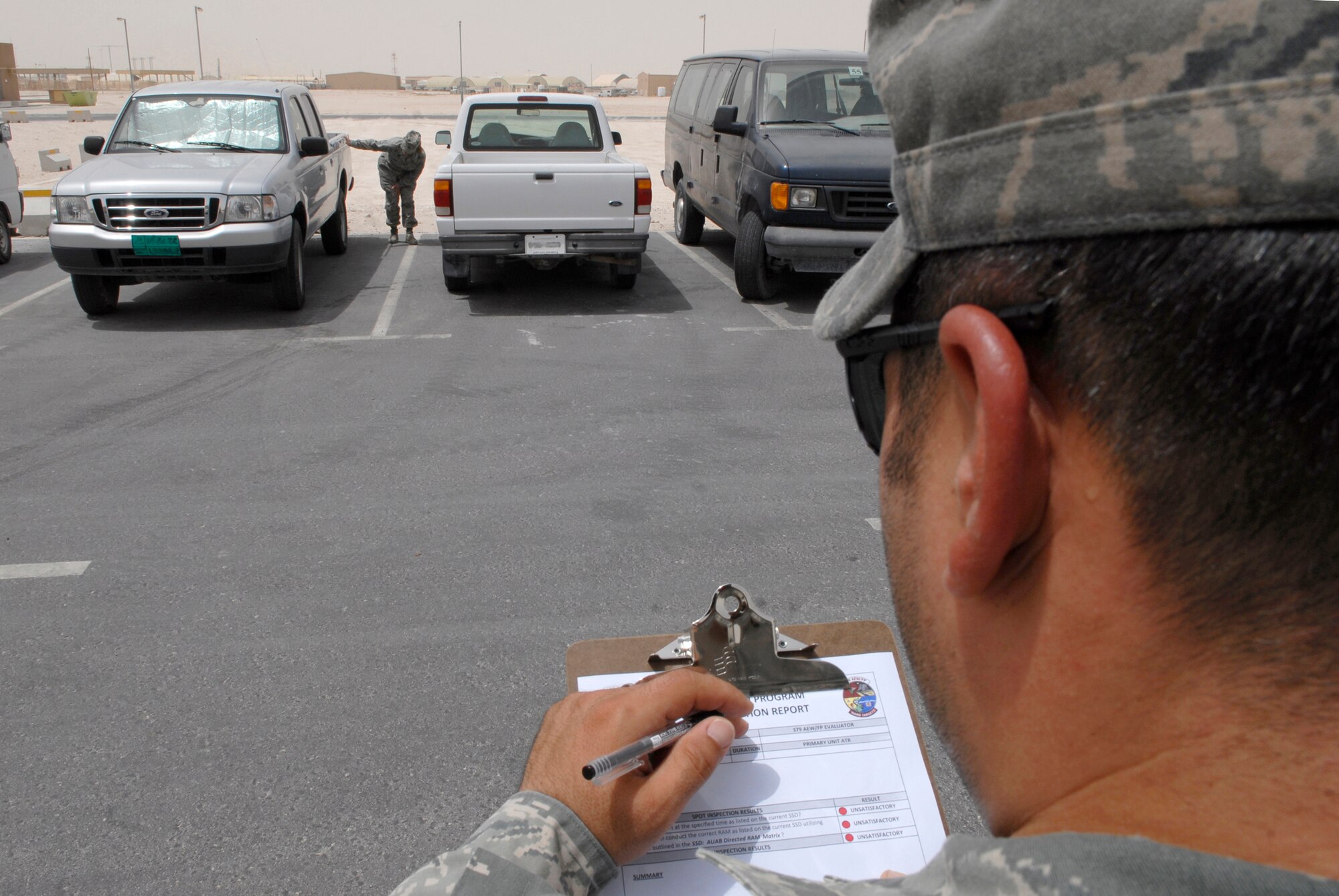 Staff Sgt. Jason Morales, 379th Air Expeditionary Wing Force Protection NCO in Charge, conducts a no-notice spot inspection on Master Sgt. Diana Shinabarger, 379th Expeditionary Operations Group Command Section Superintendent, during her unit's scheduled Random Antiterrorism Measure (RAM) inspection, June 9, 2009, at an undisclosed location in Southwest Asia.  Spot Inspections are conducted to help ensure the effectiveness of the Wing RAM Program and continues to improve it through direct feedback from personnel conducting the RAMs.  Sergeant Morales hails from Toms River, N.J. and is deployed from Ramstein Air Base, Germany.  Sergeant Shinabarger hails from Buffalo, N.Y. and is deployed from Langley Air Force Base, Va., both are deployed in support of Operations Iraqi and Enduring Freedom and Combined Joint Task Force - Horn of Africa.  (U.S. Air Force photo/Senior Airman Andrew Satran/released))       