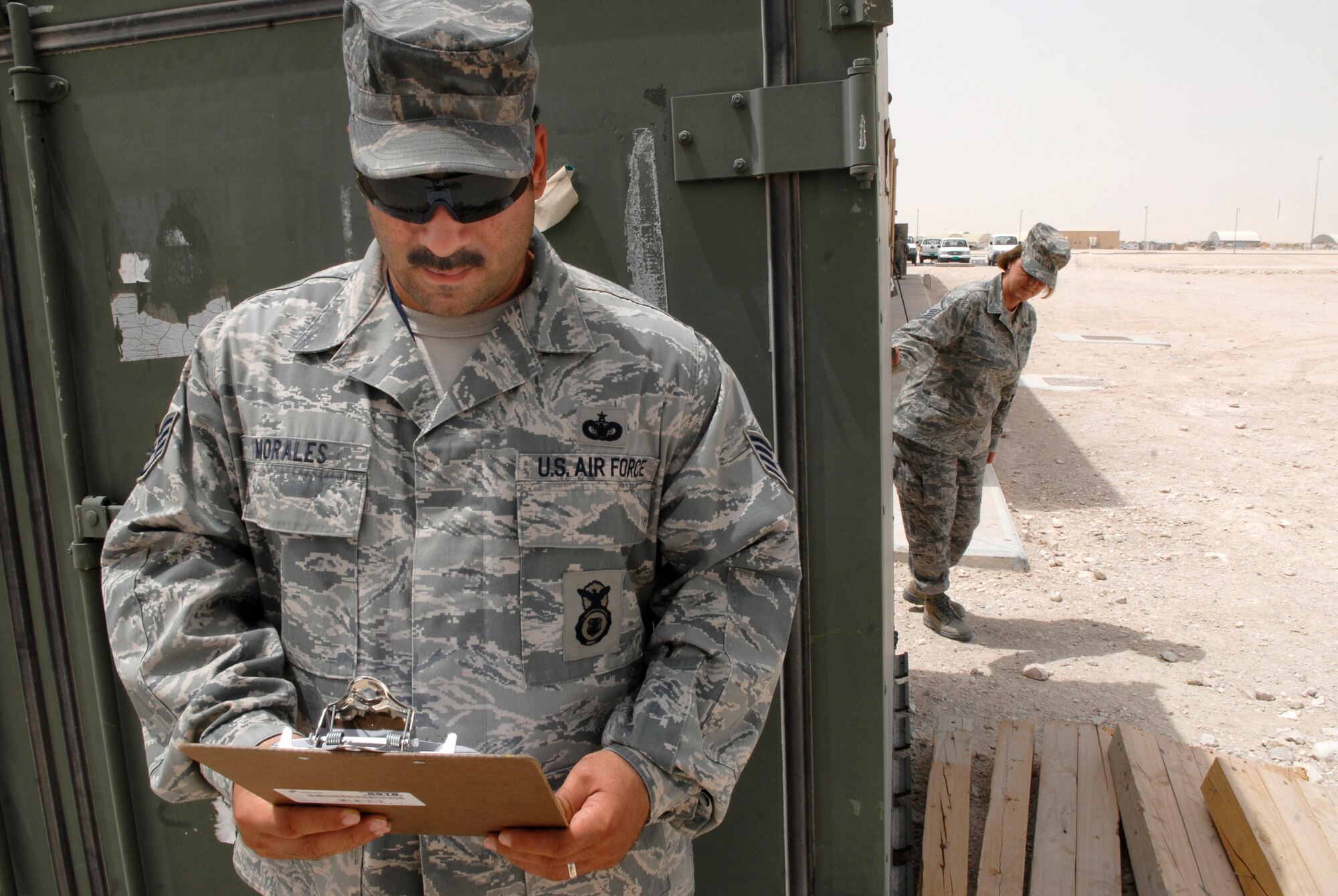 Staff Sgt. Jason Morales, 379th Air Expeditionary Wing Force Protection NCO in Charge, conducts a no-notice spot inspection on Master Sgt. Diana Shinabarger, 379th Expeditionary Operations Group Command Section Superintendent, during her unit's scheduled Random Antiterrorism Measure (RAM) inspection, June 9, 2009, at an undisclosed location in Southwest Asia.  Spot Inspections are conducted to help ensure the effectiveness of the Wing RAM Program and continues to improve it through direct feedback from personnel conducting the RAMs.  Sergeant Morales hails from Toms River, N.J. and is deployed from Ramstein Air Base, Germany.  Sergeant Shinabarger hails from Buffalo, N.Y. and is deployed from Langley Air Force Base, Va., both are deployed in support of Operations Iraqi and Enduring Freedom and Combined Joint Task Force - Horn of Africa.  (U.S. Air Force photo/Senior Airman Andrew Satran/released)  