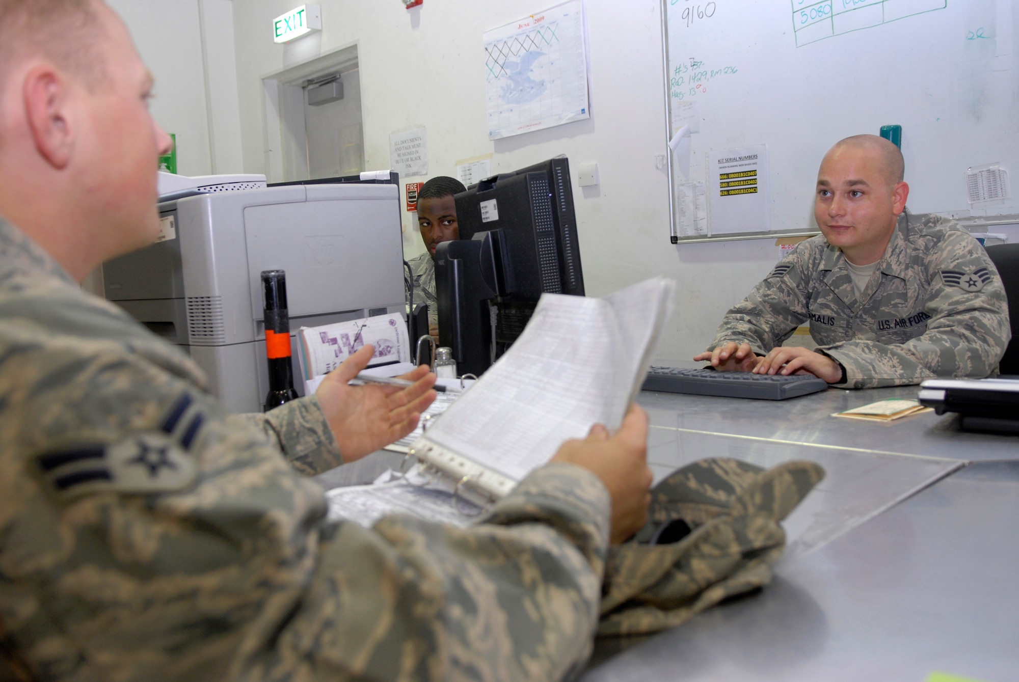 Senior Airman Brian Tamales (right), 379th Expeditionary Aircraft Maintenance Squadron combat oriented supply organization (COSO) journeyman, helps Airman 1st Class Zachary Lesser, 379th Expeditionary Aircraft Maintenance Squadron B1-B crew chief, locate a part, June 9, 2009, at an undisclosed location in Southwest Asia.  COSO personnel manage the supply of parts and assist maintenance technicians in researching and locating parts they need to perform their mission.  Airman Tamalis hails from Windsor, Conn.  Airman Lesser hails from Clarksville, Tenn.  Both are deployed from Dyess Air Force Base, Texas in support of Operations Iraqi and Enduring Freedom and Combined Joint Task Force - Horn of Africa.  (U.S. Air Force photo/Senior Airman Andrew Satran/released)