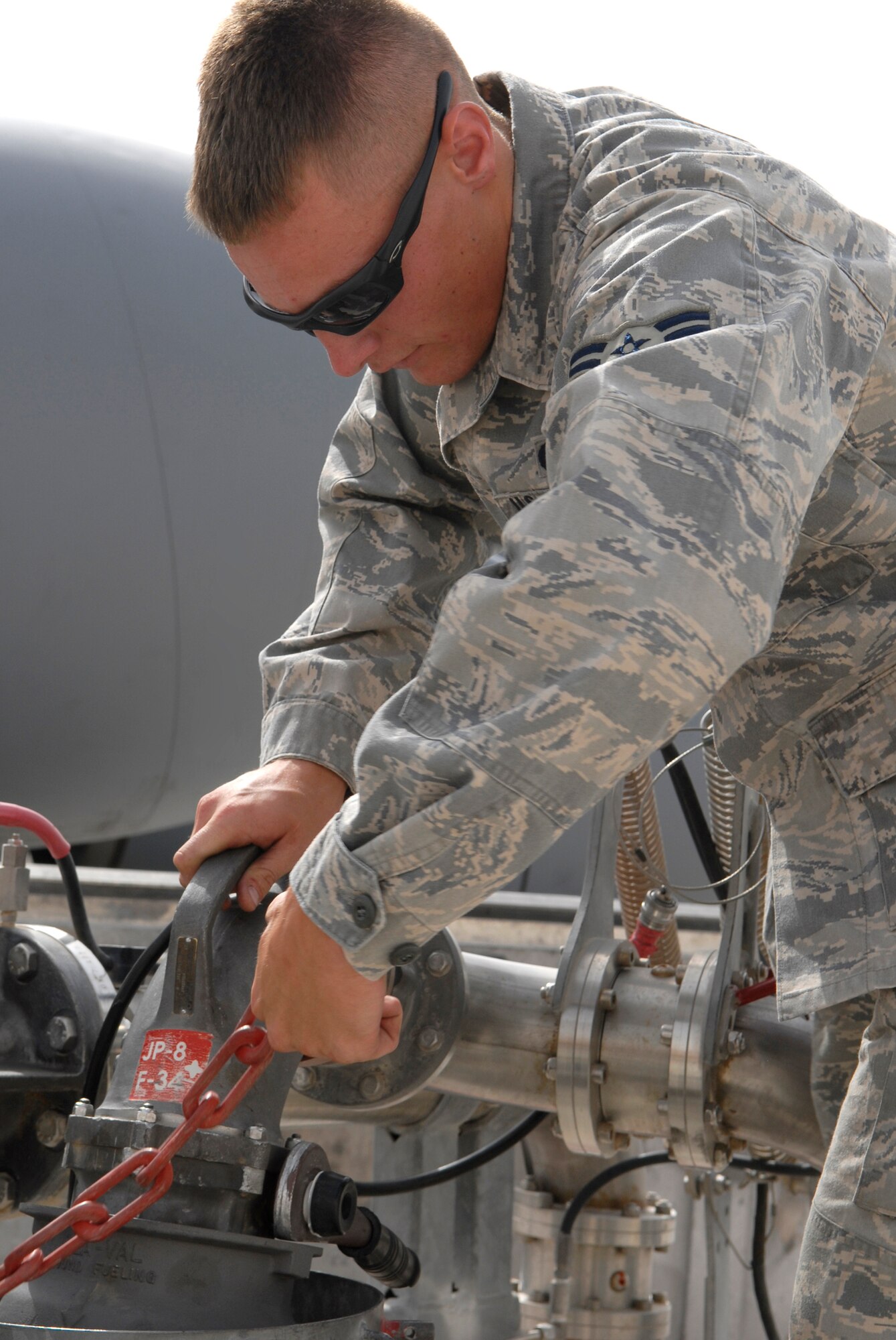 Airman 1st Class Brandon Sullivan, 379th Expeditionary Logistics Readiness Squadron fuels distribution operator, breaks down a refueling pantograph after fueling a KC-135R Stratotanker, June 10, 2009, at an undisclosed location in Southwest Asia.  Airman Sullivan pumped 16,083 gallons of JP-8 fuel at 457 gallons per minute through the system to refuel the aircraft.  Fuel distribution operators deliver fuel to aircraft around the clock everyday of the year to meet the ongoing demands of the mission.  Airman Sullivan hails from Burlington, Iowa and is deployed from Kadena Air Base, Japan, in support of Operations Iraqi and Enduring Freedom and Combined Joint Task Force - Horn of Africa.  (U.S. Air Force photo/Senior Airman Andrew Satran/released)  