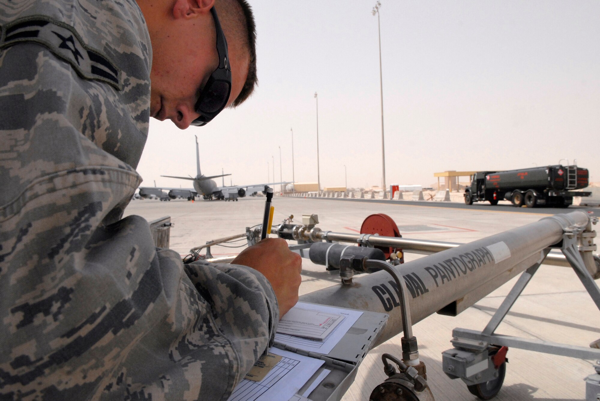 Airman 1st Class Brandon Sullivan, a 379th Expeditionary Logistics Readiness Squadron fuels distribution operator, writes out a receipt for an issued amount of fuel after refueling a KC-135R Stratotanker, June 10, 2009, at an undisclosed location in Southwest Asia.  Airman Sullivan pumped 16,083 gallons of JP-8 fuel at 457 gallons per minute through the system to refuel the aircraft.  Fuel distribution operators deliver fuel to aircraft around the clock everyday of the year to meet the ongoing demands of the mission.  Airman Sullivan hails from Burlington, Iowa and is deployed from Kadena Air Base, Japan, in support of Operations Iraqi and Enduring Freedom and Combined Joint Task Force - Horn of Africa.  (U.S. Air Force photo/Senior Airman Andrew Satran/released)  