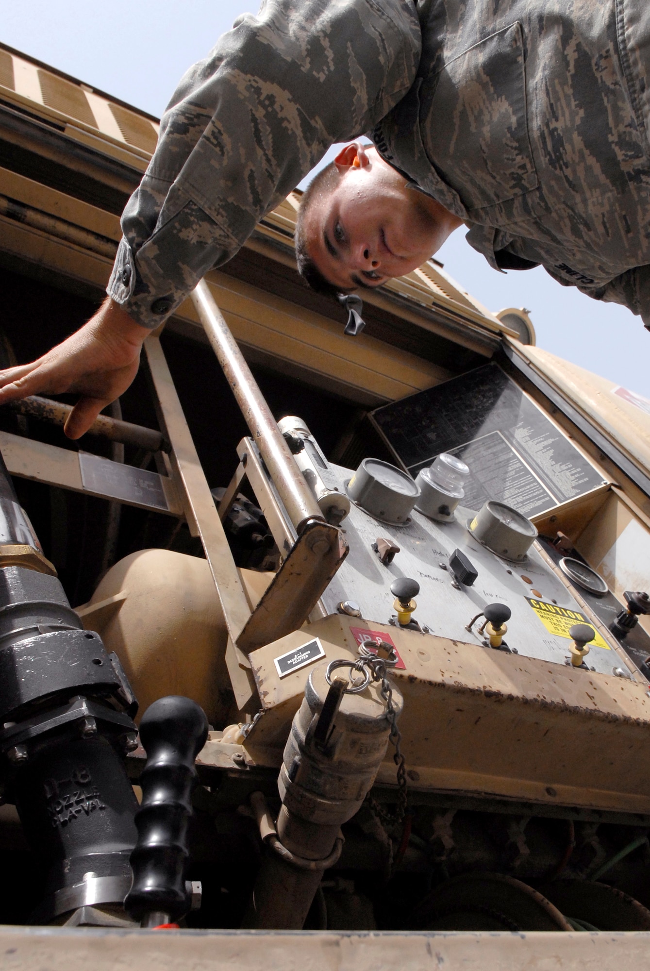 Airman Jordan Cline, a 379th Expeditionary Logistics Readiness Squadron fuels distribution operator, returns a hose to the R-11 fuel truck after refueling a KC-135R Stratotanker, June 10, 2009, at an undisclosed location in Southwest Asia.  Fuel distribution operators deliver fuel to aircraft around the clock everyday of the year to meet the ongoing demands of the mission.  Airman Cline hails from Sacramento, Calif. and is deployed from Barksdale Air Force Base, La. in support of Operations Iraqi and Enduring Freedom and Combined Joint Task Force - Horn of Africa.  (U.S. Air Force photo/Senior Airman Andrew Satran/released)  