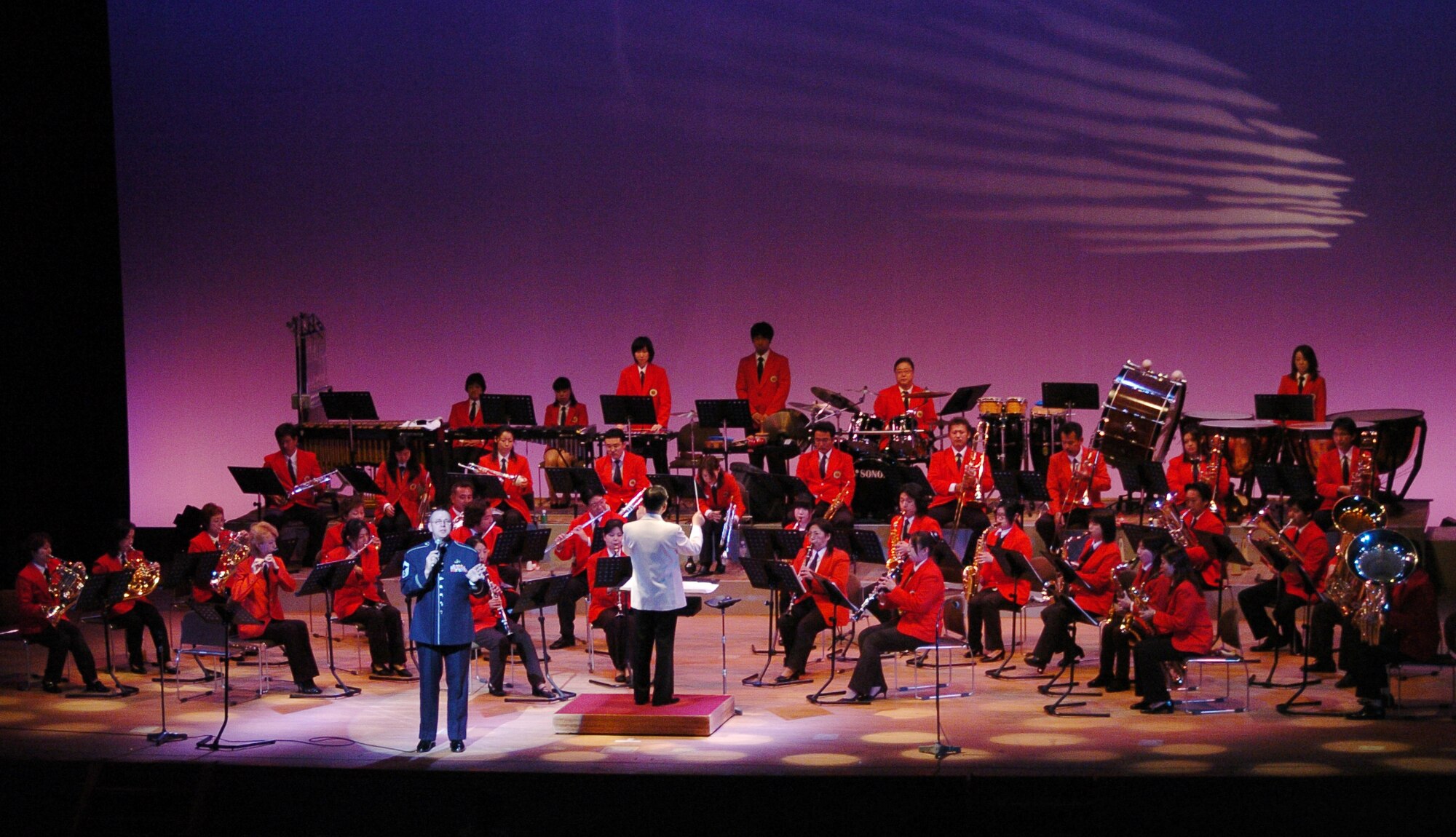 MIZUHO, Japan -- Senior Master Sgt. Daniel Smalley, U.S. Air Force Band of the Pacific-Asia, performs June 14 during a concert by the Mizuho Youth Symphonic Band at the Mizuho Viewpark Sky Hall. Sergeant Smalley sang a variety of numbers, including "I Left My Heart in San Francisco" and "New York, New York" for a crowd of more than 300. (U.S. Air Force photo/Master Sgt. Matt Summers)