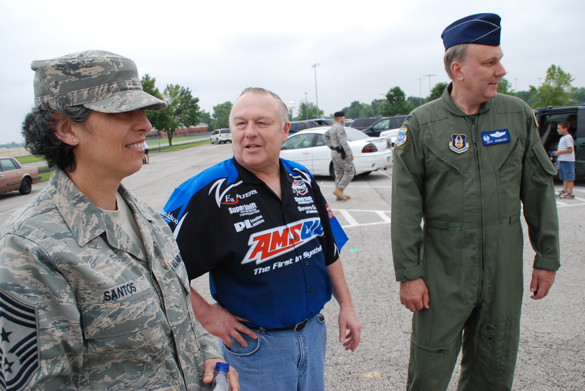 932nd Airlift Wing Command Chief Master Sgt. Sandra Santos and 932nd Airlift Wing Vice Commander, Col. Jeff Johnson meet up with retired wing member Senior Master Sgt. Bob Salter who now runs a race car team with family members in Illinois.  All were on hand at Scott Air Force Base to be part of the base picnic recently.  (U.S. Air Force photo/Maj. Stan Paregien)