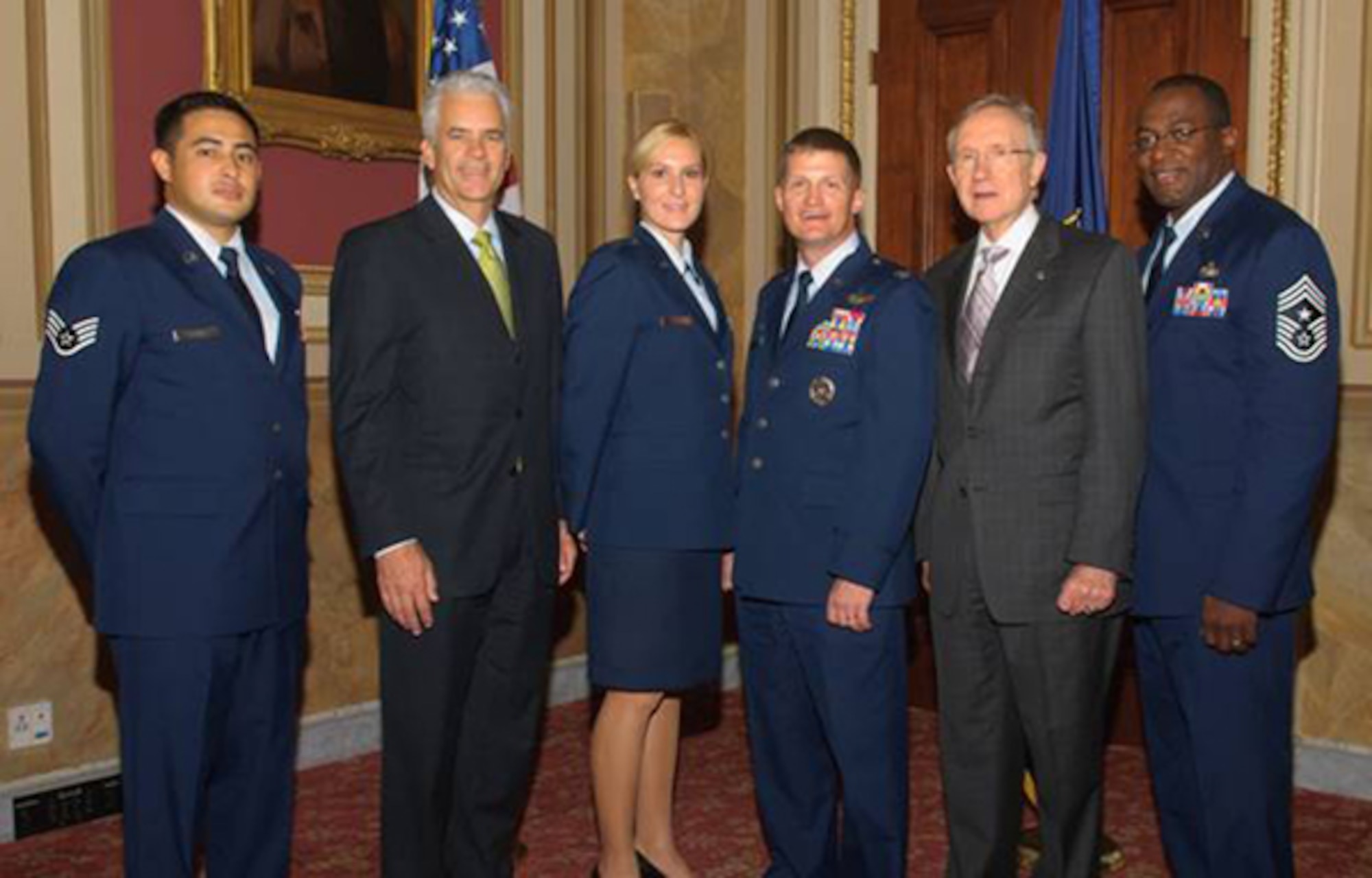 Col. Dave Belote, 99th Air Base Wing commander, and Command Chief Master Sgt. Alfred Herring led a team of Nellis representatives to Capitol Hill to discuss issues affecting Airmen during the 2009 Congressionl visit June 10-11. During the visit, Nellis representatives attended a breakfast hosted by Nevada Senators Harry Reid and John Ensign. (Pictured left to right: Staff Sgt. Tim Klave, Senator John Ensign, Capt. Amanda Ferrell, Col. Dave Belote, Senator Harry Reid, Command Chief Master Sgt. Alfred Herring.) 