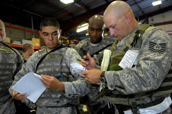 SHAW AIR FORCE BASE, S.C. -- Airman 1st Class Christopher Cox, 20th Security Forces Squadron personnel, left, and Tech. Sgt. Jesse Evans, 20th Civil Engineer Squadron, right, review instructions for their convoy at the start of Team Shaw's operational readiness inspection, June 15. The ORI will evaluate Shaw's ability to survive and operate in combat conditions. (U.S. Air Force photo/Senior Airman Kathrine McDowell) 

