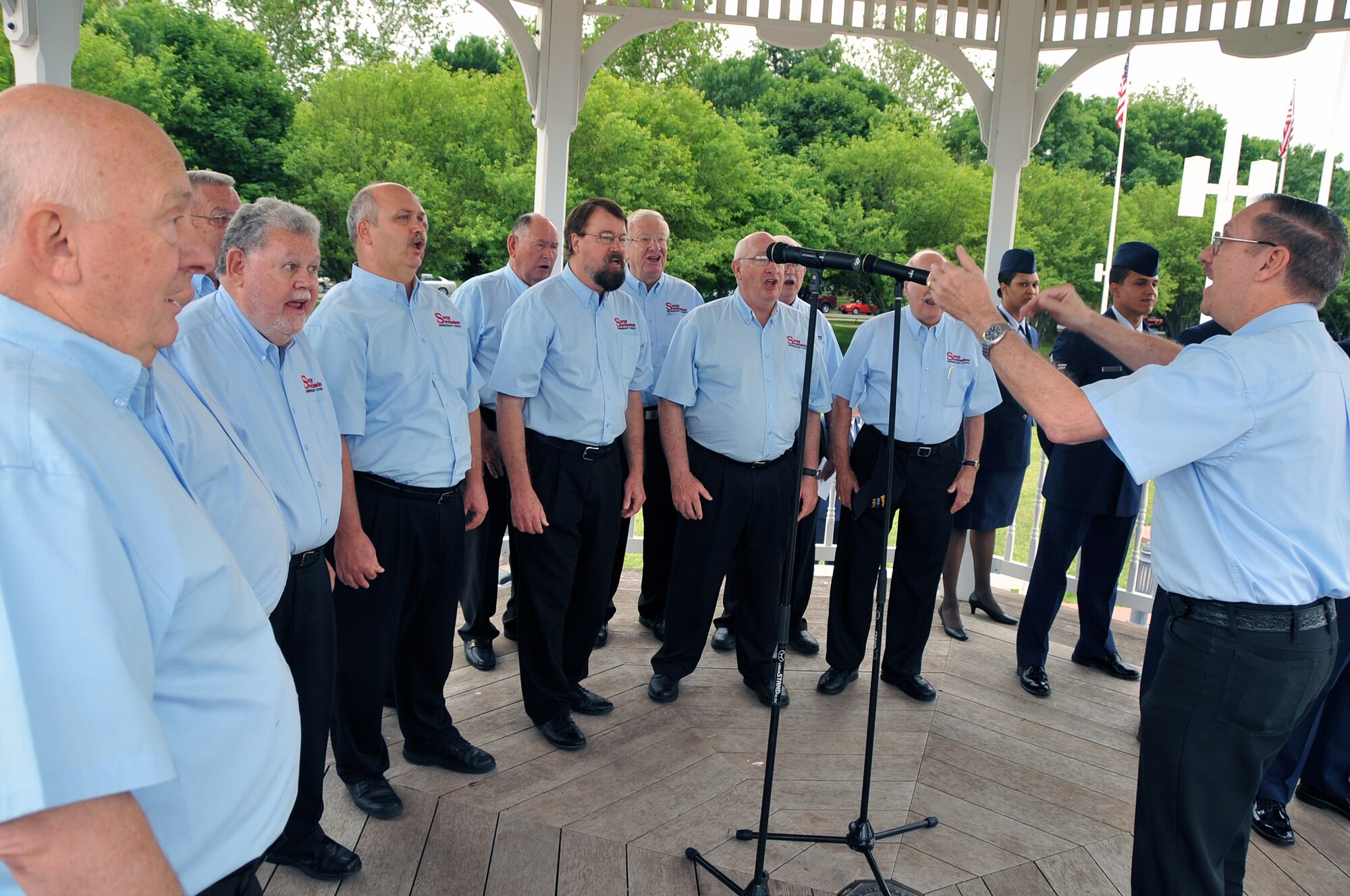 OFFUTT AIR FORCE BASE, Ne. -- The Sarpy Serenaders, a local barbershop chorus, sing patriotic songs and hymns to honor Old Glory during Offutt's Flag Day ceremony at the parade grounds here June 12. Most the group's members served in the United States military. U.S. Air Force Photo by Jeff W. Gates