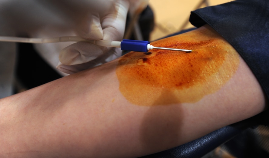MOODY AIR FORCE BASE, Ga. -- Senior Airman Angela Land, 23rd Equipment Maintenance Squadron aircraft structural maintenance journeyman, waits patiently while a technician draws blood during an American Red Cross blood drive here June 12. (U.S. Air Force photo by Airman 1st Class Joshua Green)