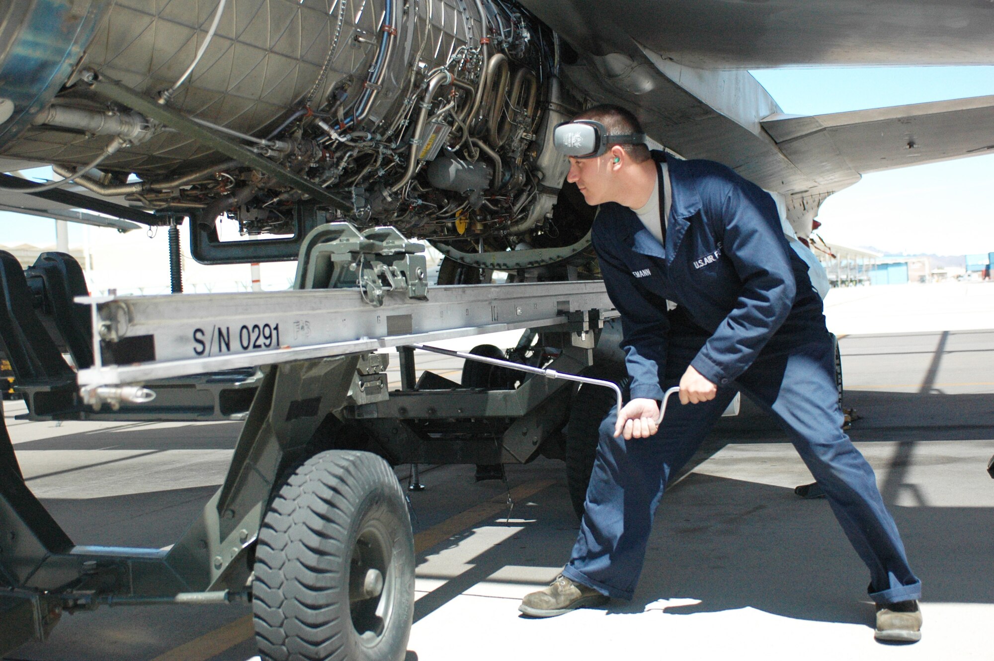 Airman First Class Josh Hegemann, an F-16 crew chief, installs an engine on the 162nd Fighter Wing flightline wearing newly-issued coveralls, June 10. Airman Hegemann, along with numerous other maintainers, wears the Airman Battle Uniform to work and changes into coveralls to protect his uniform from oil, fuel, lubricant and other petroleum products. (Air National Guard photo by Capt. Gabe Johnson)