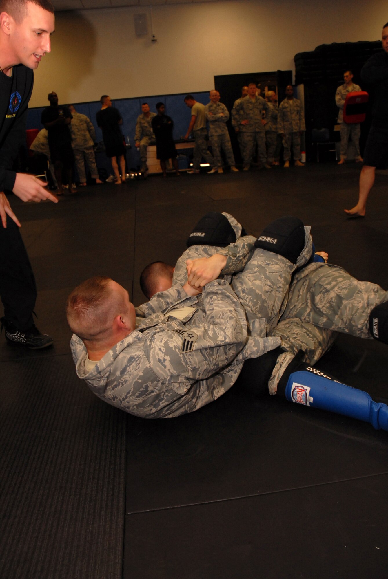 Fly-Away Security Team (FAST) instructor, Tech. Sgt. Shane Spice, 421 Combat Training Squadron, guides a student in the proper application of an arm bar during a training match at the U.S. Air Force Expeditionary Center, Joint Base McGuire-Dix-Lakehurst, N.J. on June 4, 2009. FAST members provide airfield assessment and aircraft security for Air Force Central Command  transient resources. (U.S. Air Force Photo/Tech. Sgt. Paul R. Evans)