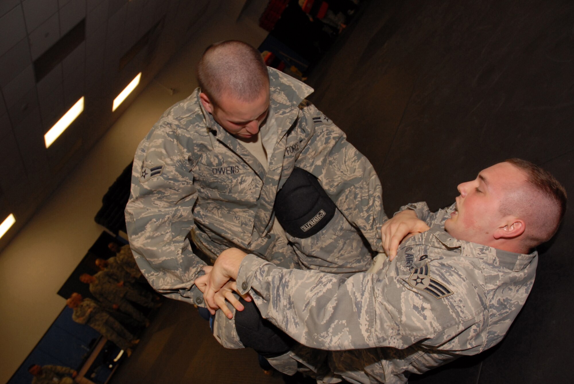 Airman First Class Brandon Owens, a Fly-Away Security Team (FAST) student from Bolling AFB, attempts to gain a dominant position on his classmate during a ground fighting training exercise at the U.S. Air Force Expeditionary Center, Joint Base McGuire-Dix-Lakehurst, N.J. on June 4, 2009. FAST members provide airfield assessment and aircraft security for Air Force Central Command  transient resources. (U.S. Air Force Photo/Tech. Sgt. Paul R. Evans)