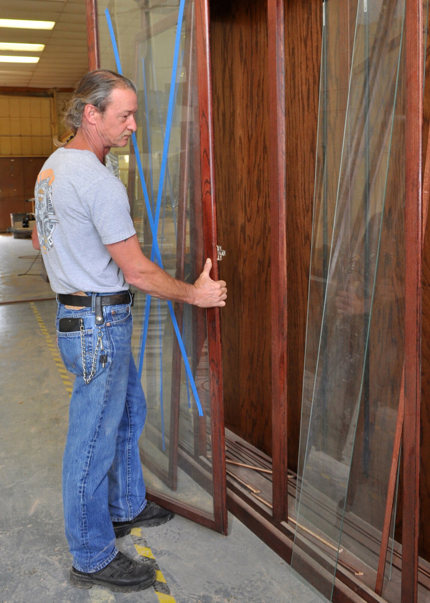 Mike Jarrett, 2nd Force Support Squadron, woodcraft manager, prepares the last section of a trophy case for shipment at the Wood Hobby Shop at Barksdale Air Force Base, La., June 15, 2009. The trophy case, which is 24 feet long and 90 inches tall, is destined for the 917th Wing Headquarters building where it will display historical items for visitors to the 917th Wing. Construction on the case started in November 2008, but due to the overwhelming demand for retirement cases it has taken longer than expected to finish the project. Mr. Jarrett plans to have the trophy case completely installed in the 917th Headquarters building by the end of the week. (U.S. Air Force photo/Tech. Sgt. Jeff Walston)