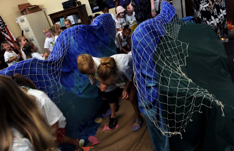 MOODY AIR FORCE BASE, Ga. -- Moody children walk through a simulated version of the Red Sea during Bible Camp here June 12. The camp is a week-long program that allows children to gain knowledge of the Bible by allowing them to experience the scriptures through different activities. (U.S. Air Force photo by Airman 1st Class Joshua Green)